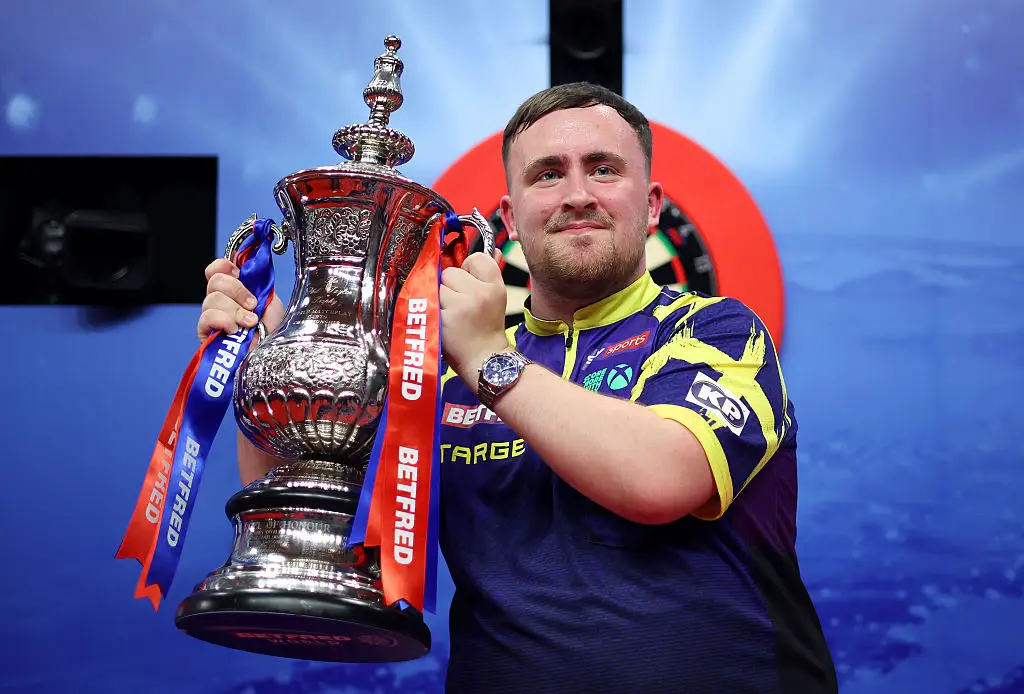 Luke Littler lifted the Phil Taylor Trophy after defeating James Wade (Image: Getty)
