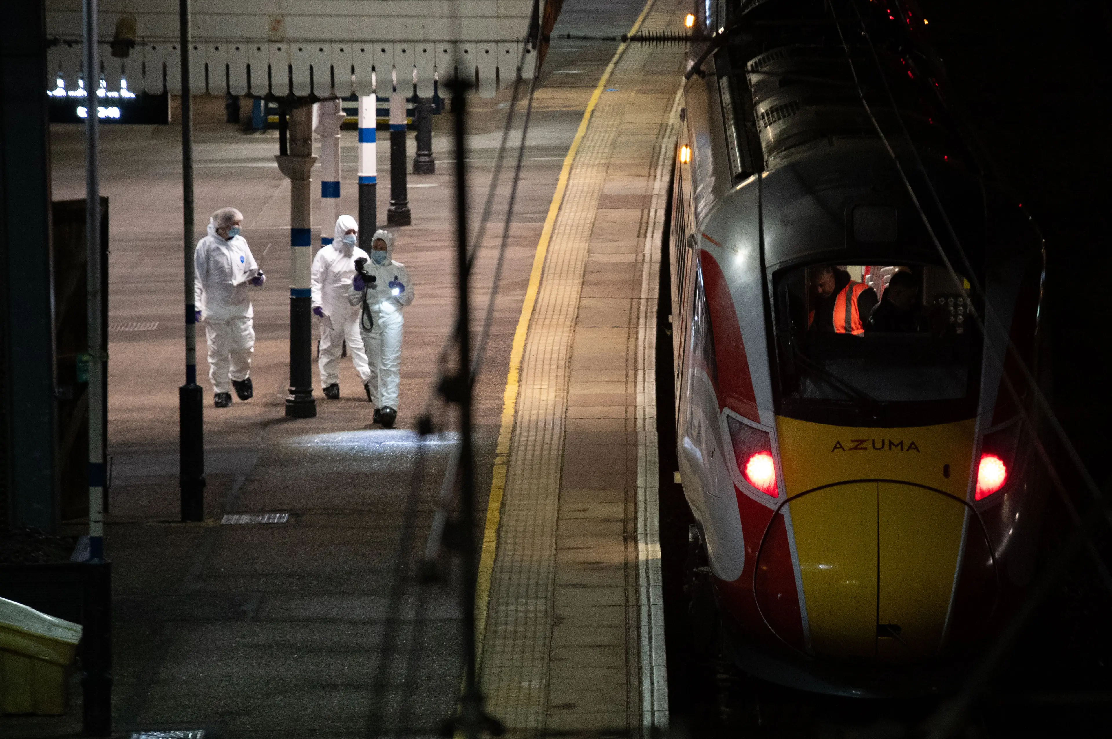 Crime scene investigators walk along a train platform at Huntingdon Station on November 2, 2025. Image credit: Getty