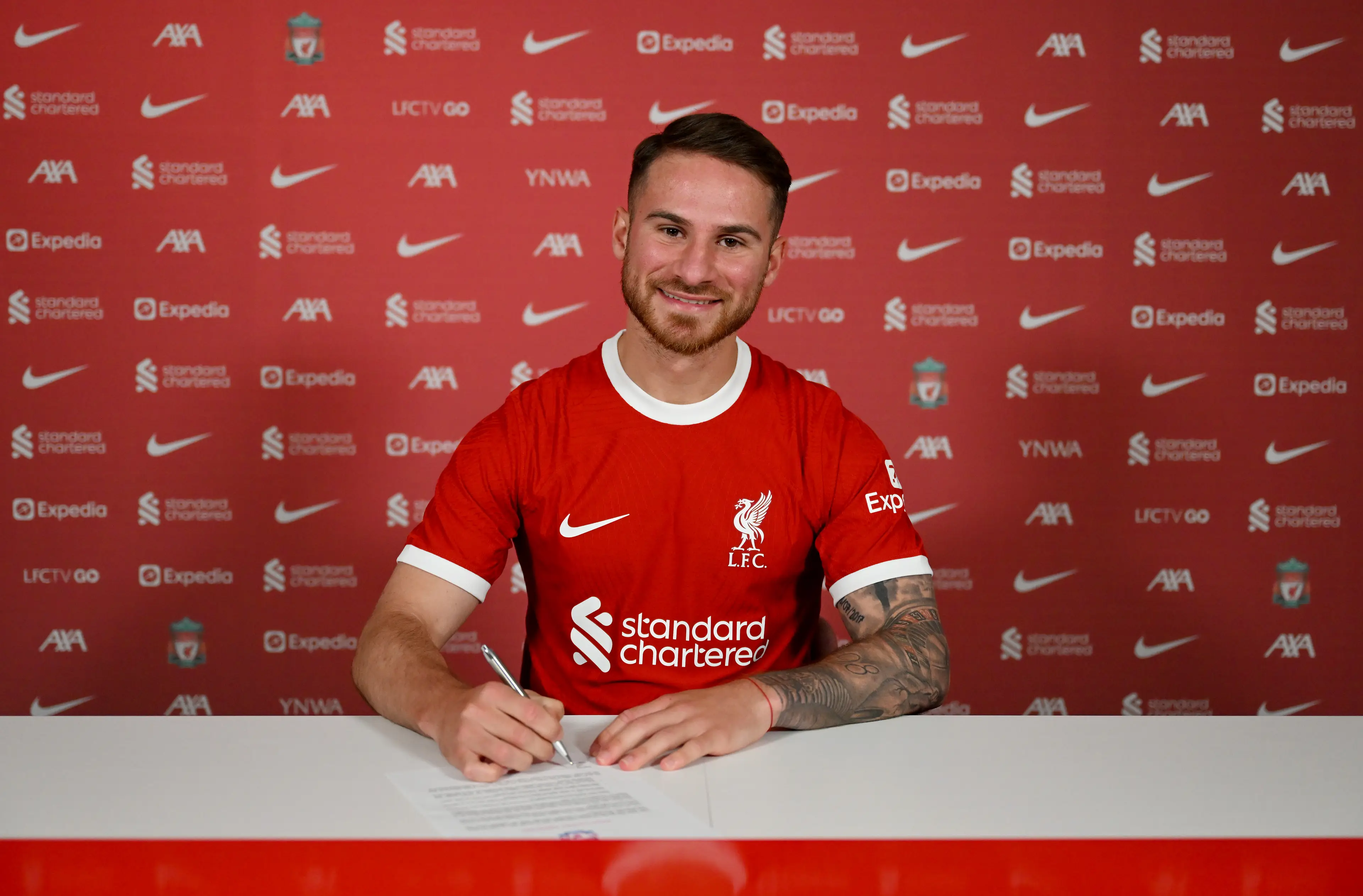 Alexis Mac Allister signs his Liverpool contract. Image: Getty