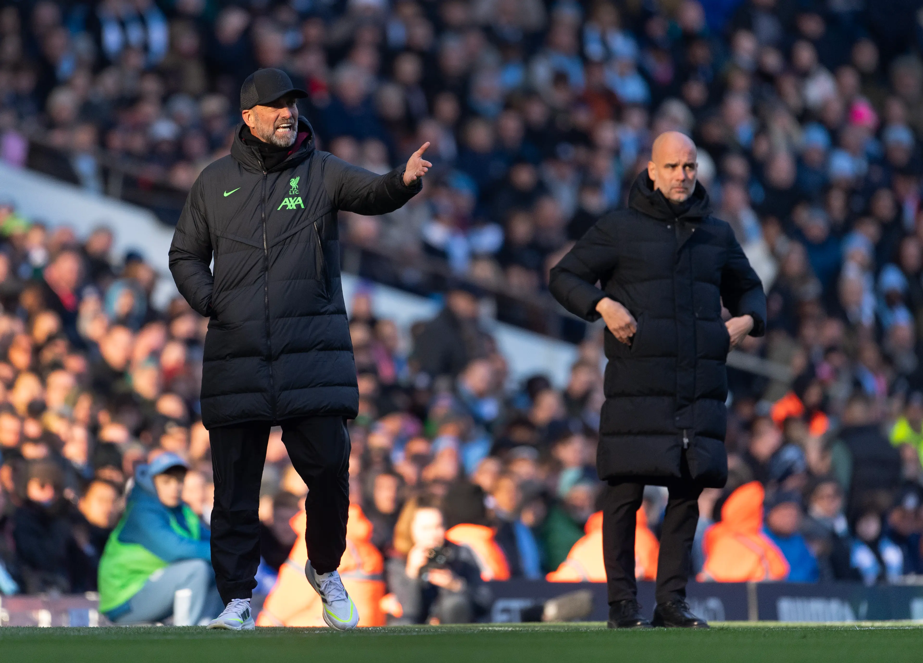 Jurgen Klopp and Pep Guardiola on the touchline for a Premier League game. Image: Getty