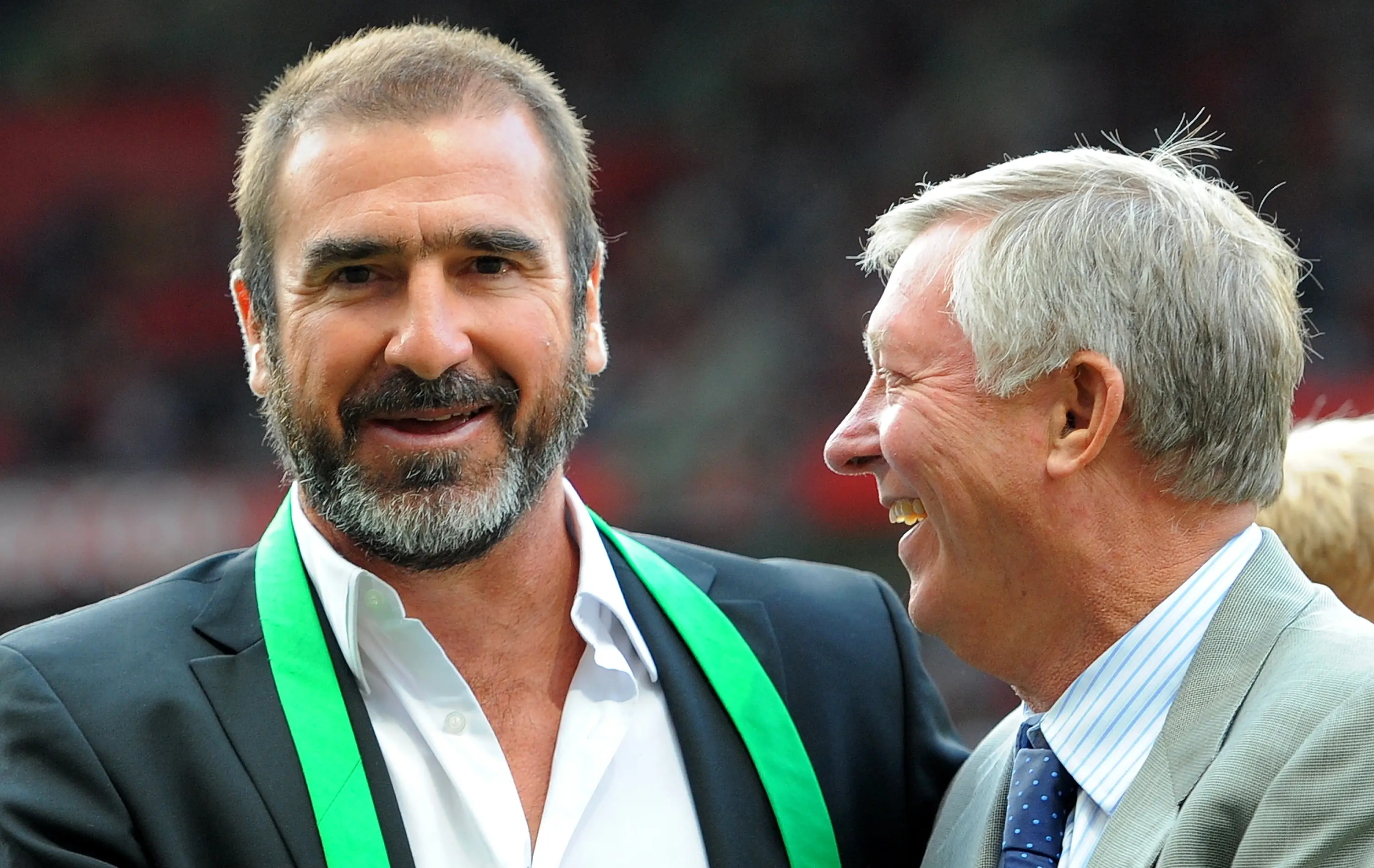 Eric Cantona shares a warm embrace with Sir Alex Ferguson. Image: Getty