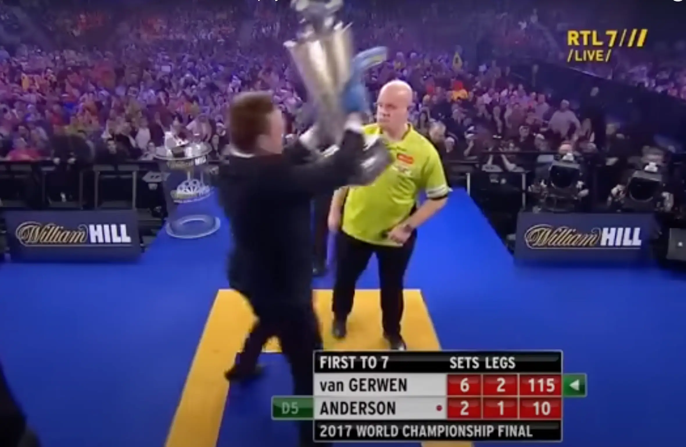 Michael van Gerwen looked one as a fan stole the trophy he was about to win. Image: RTL 7