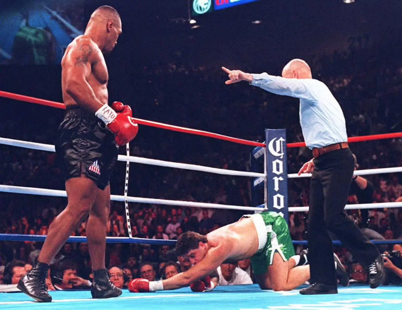 Mike Tyson stands over Peter McNeeley after knocking him to the canvas. Image: Getty