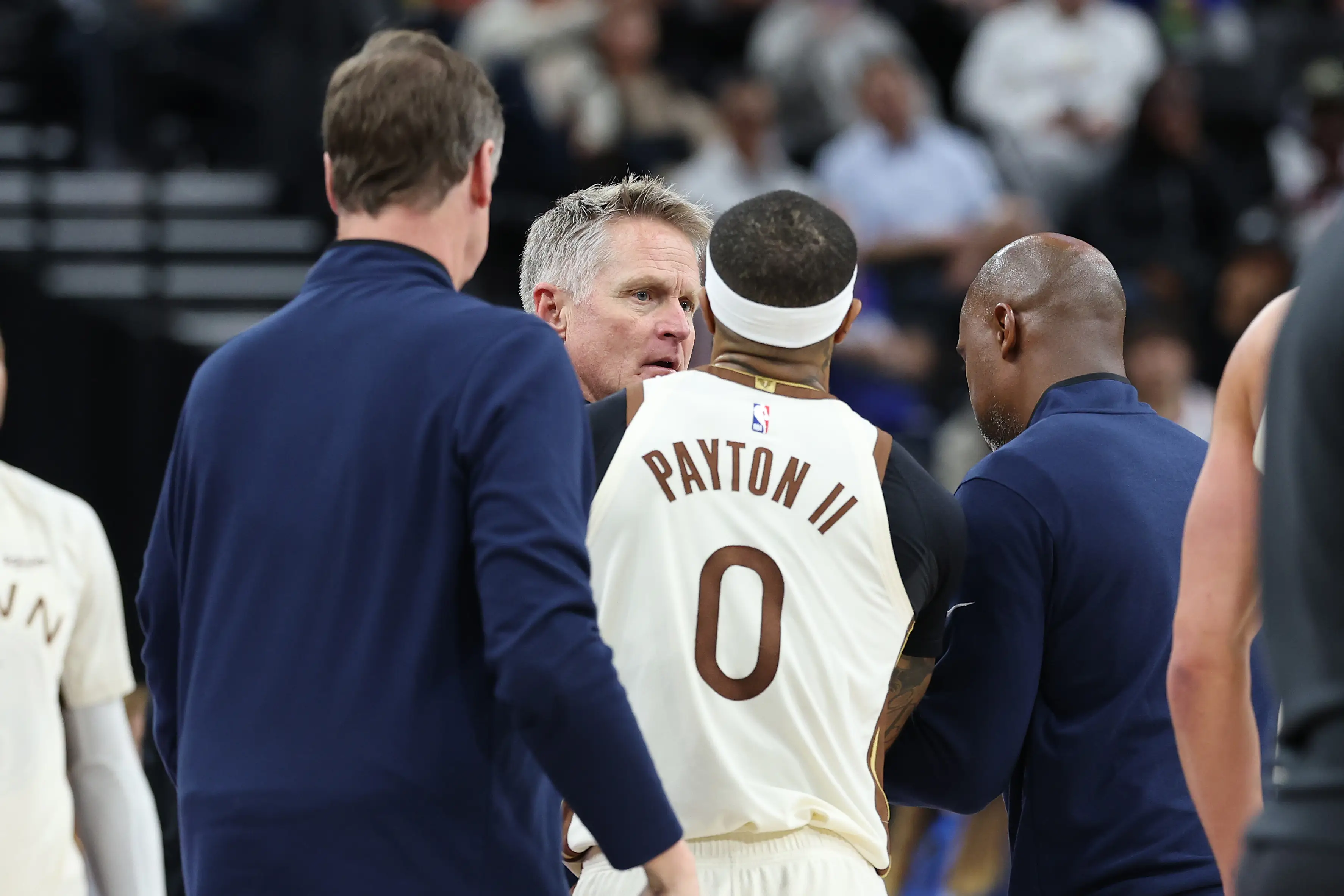 Gary Payton II restrains Steve Kerr after he was ejected from the game for arguing with officials. Image: Getty 