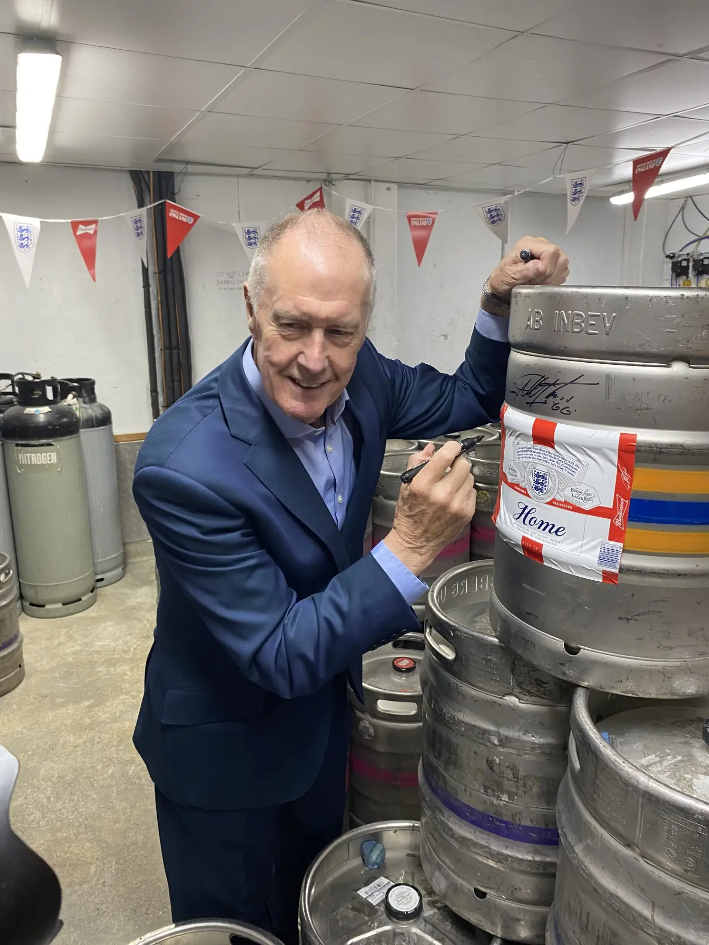 Sir Geoff Hurst signing the keg