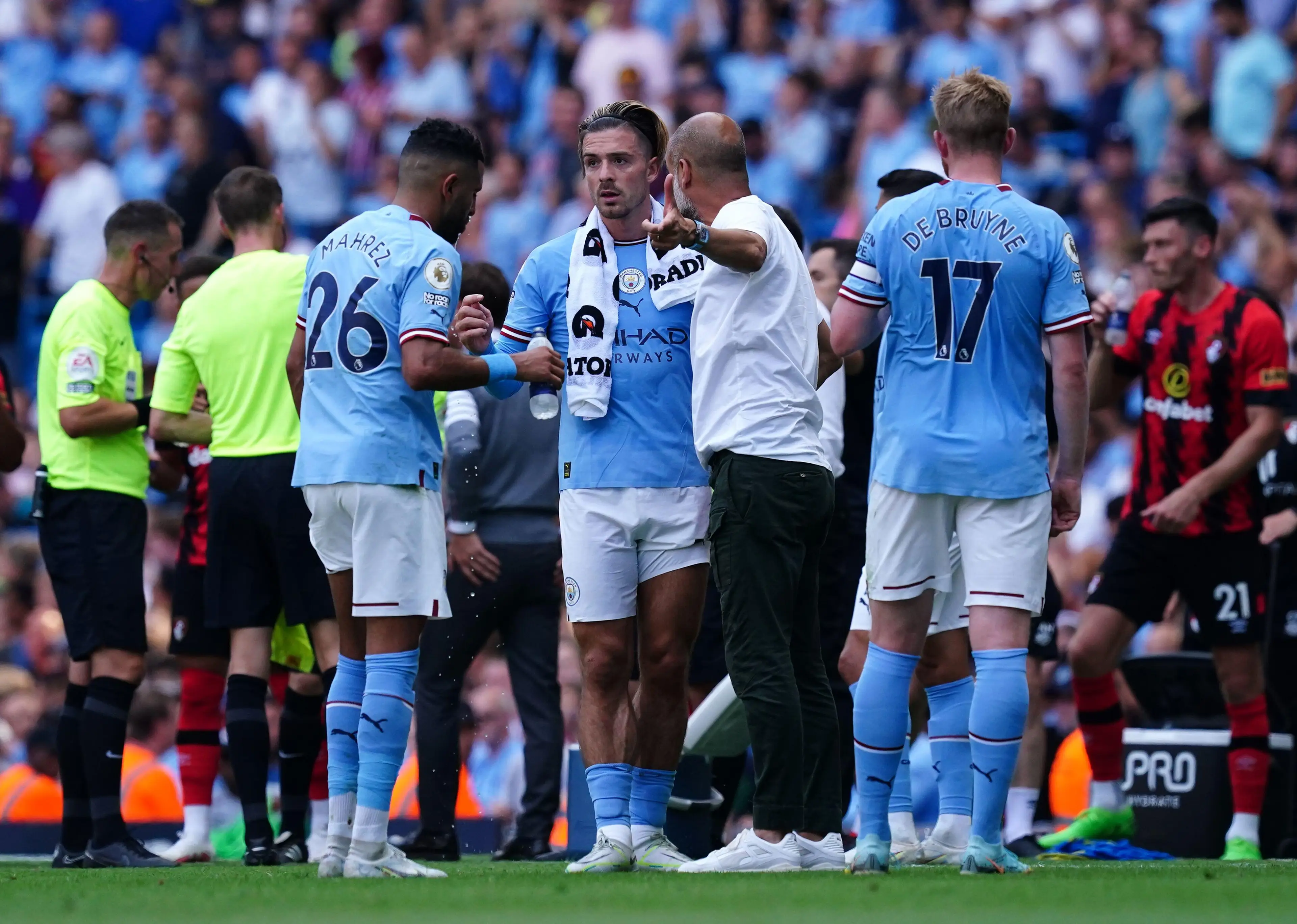 Jack Grealish in a tactical discussion with Pep Guardiola. (PA Images / Alamy)