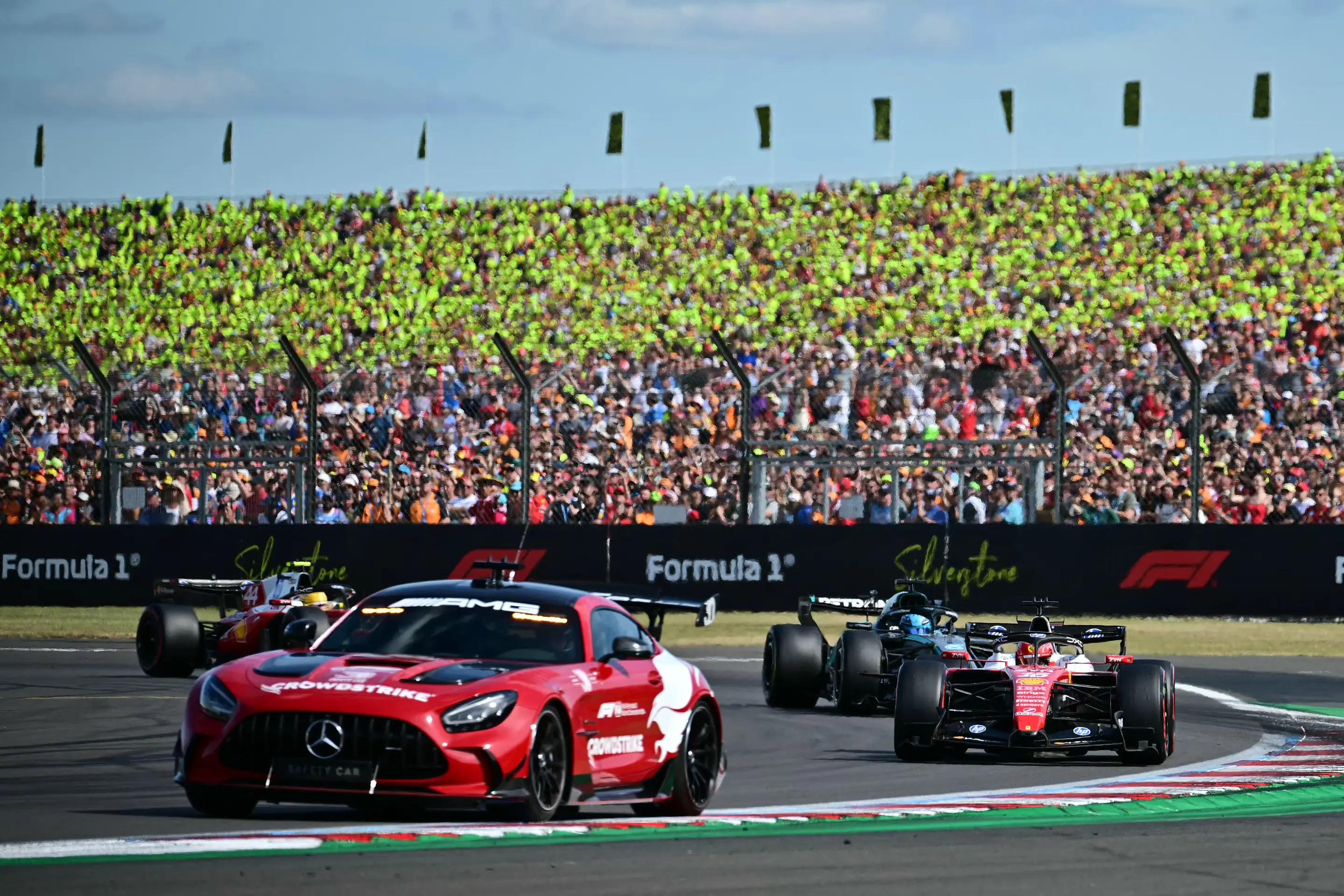 Ferrari's Monegasque driver Charles Leclerc (R), Mercedes' British driver George Russell (2R) and Ferrari's British driver Lewis Hamilton (L) tucked in behind the safety car (2L) (Getty Images)