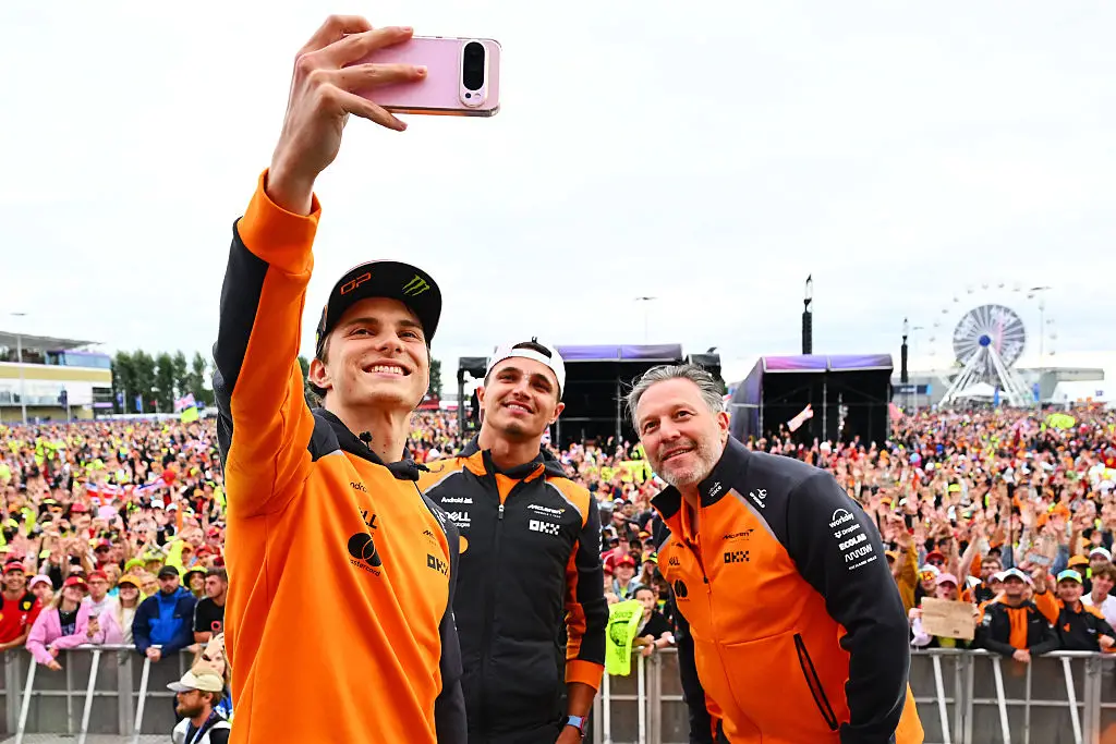 Oscar Piastri, Lando Norris and McClaren exec Zak Brown at the Silverstone fan stage in 2025