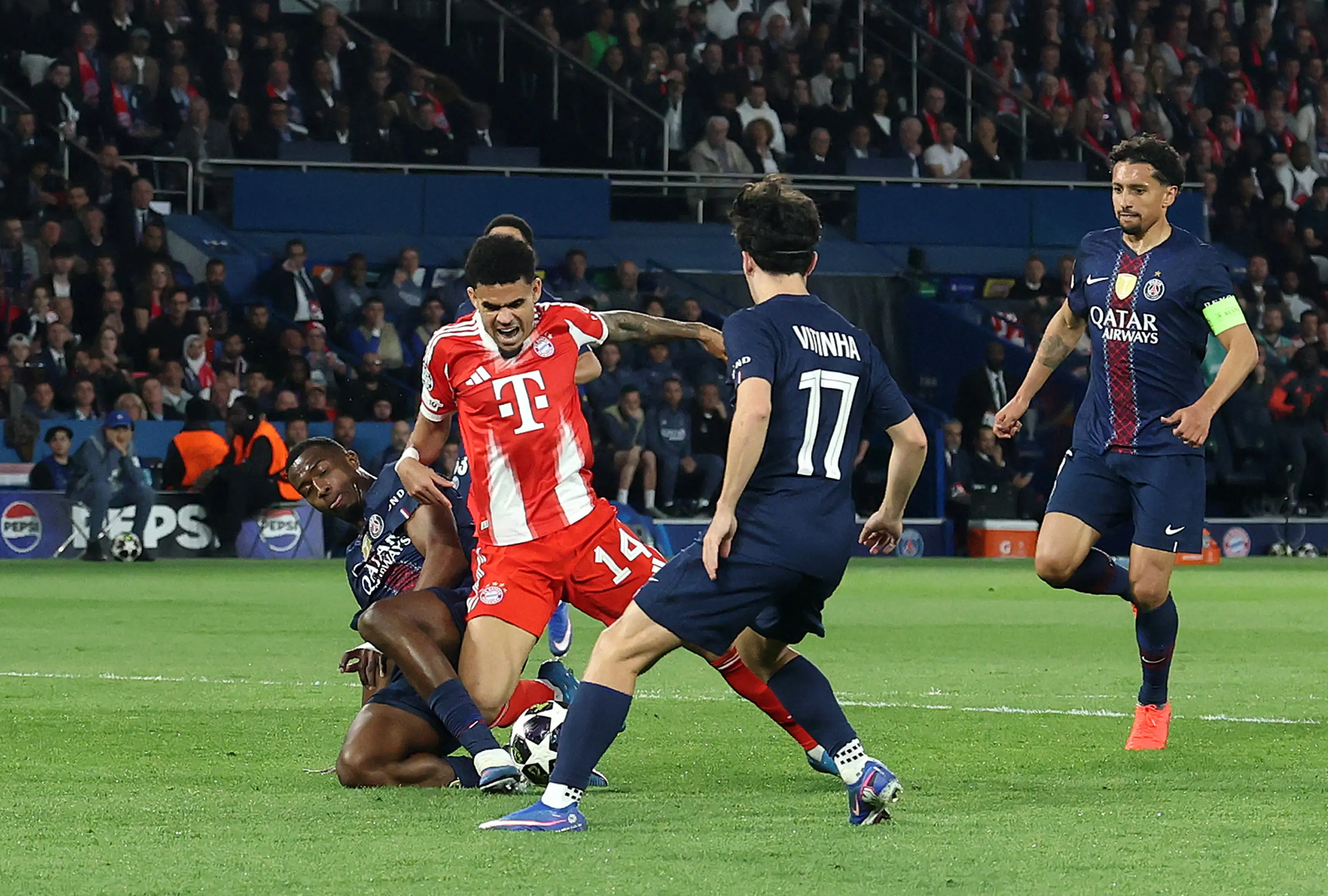 Luis Diaz of FC Bayern Munich is fouled by William Pacho of Paris Saint-Germain leading to a penalty being awarded during the UEFA Champions League 
