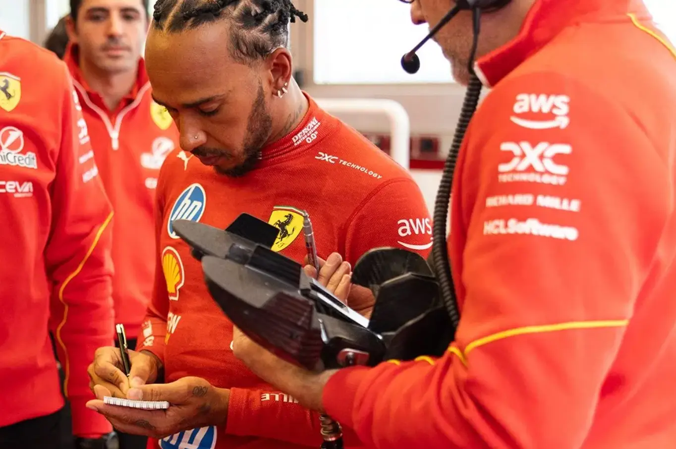 Hamilton could be seen taking notes throughout. Image credit: Ferrari