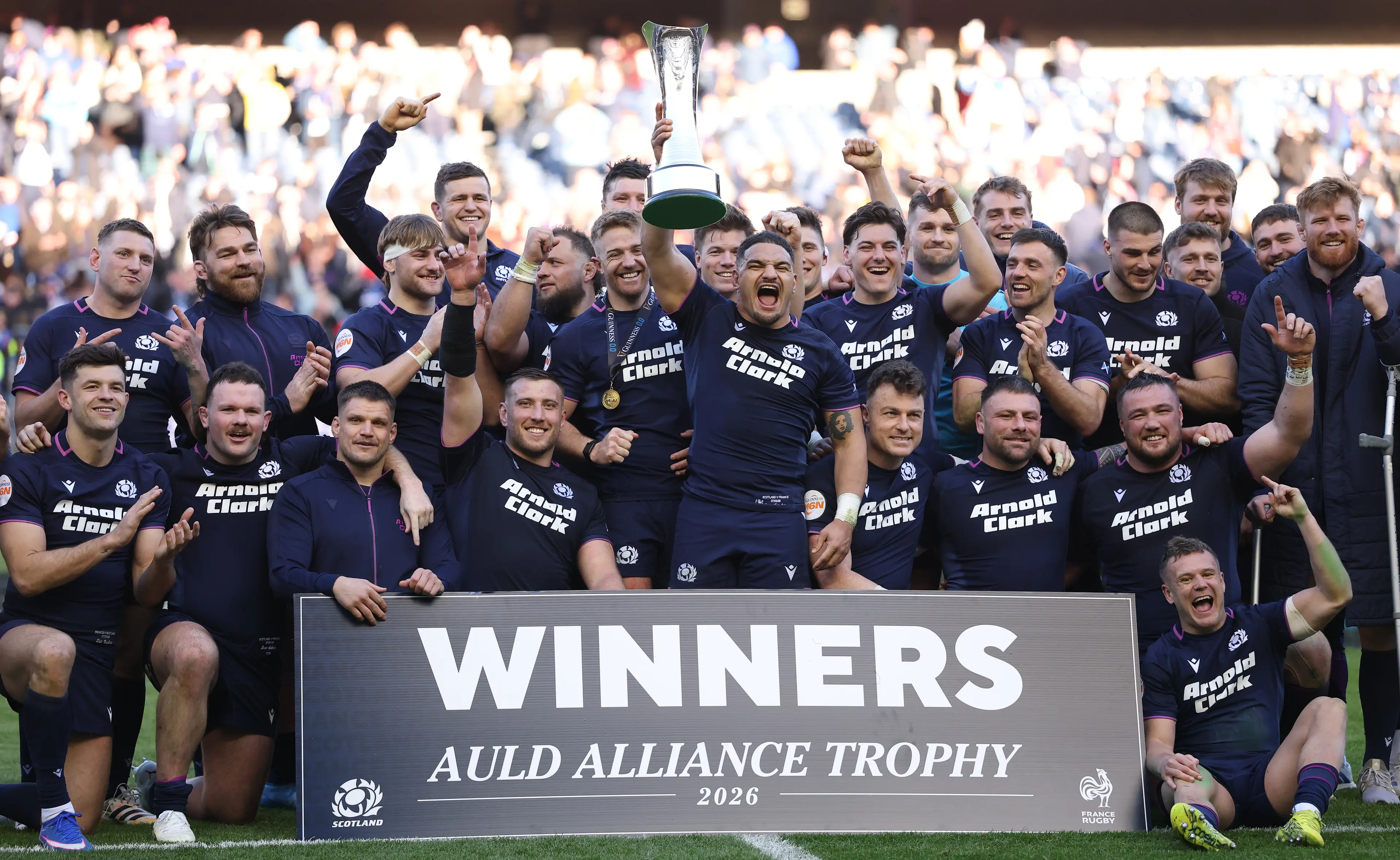 Scotland captain Sione Tuipulotu holds aloft the trophy and celebrates with team mates after the Guinness Six Nations 2026 match between Scotland and France