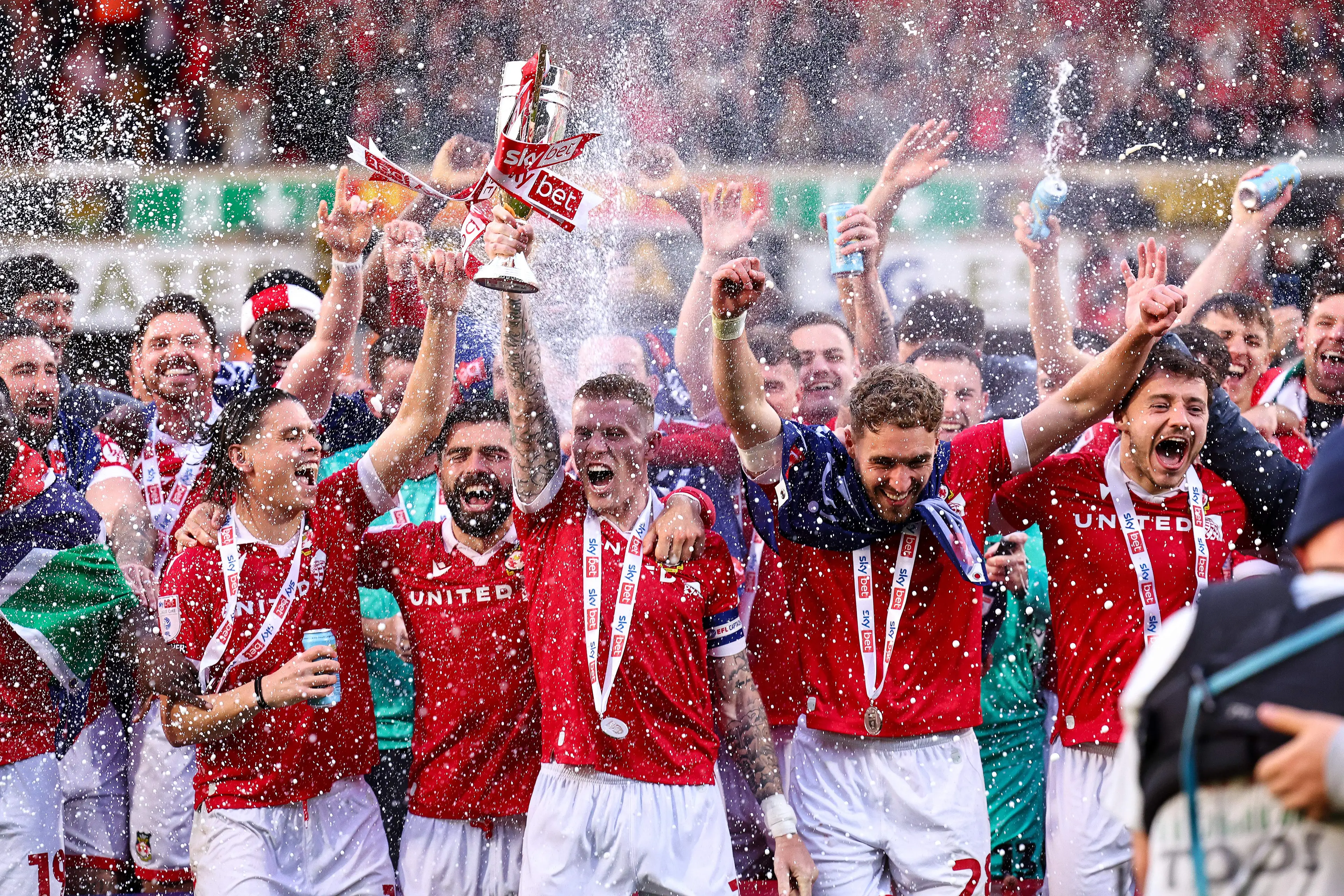 James McClean lifts the trophy after Wrexham secured promotion to the Championship (Image: Getty)