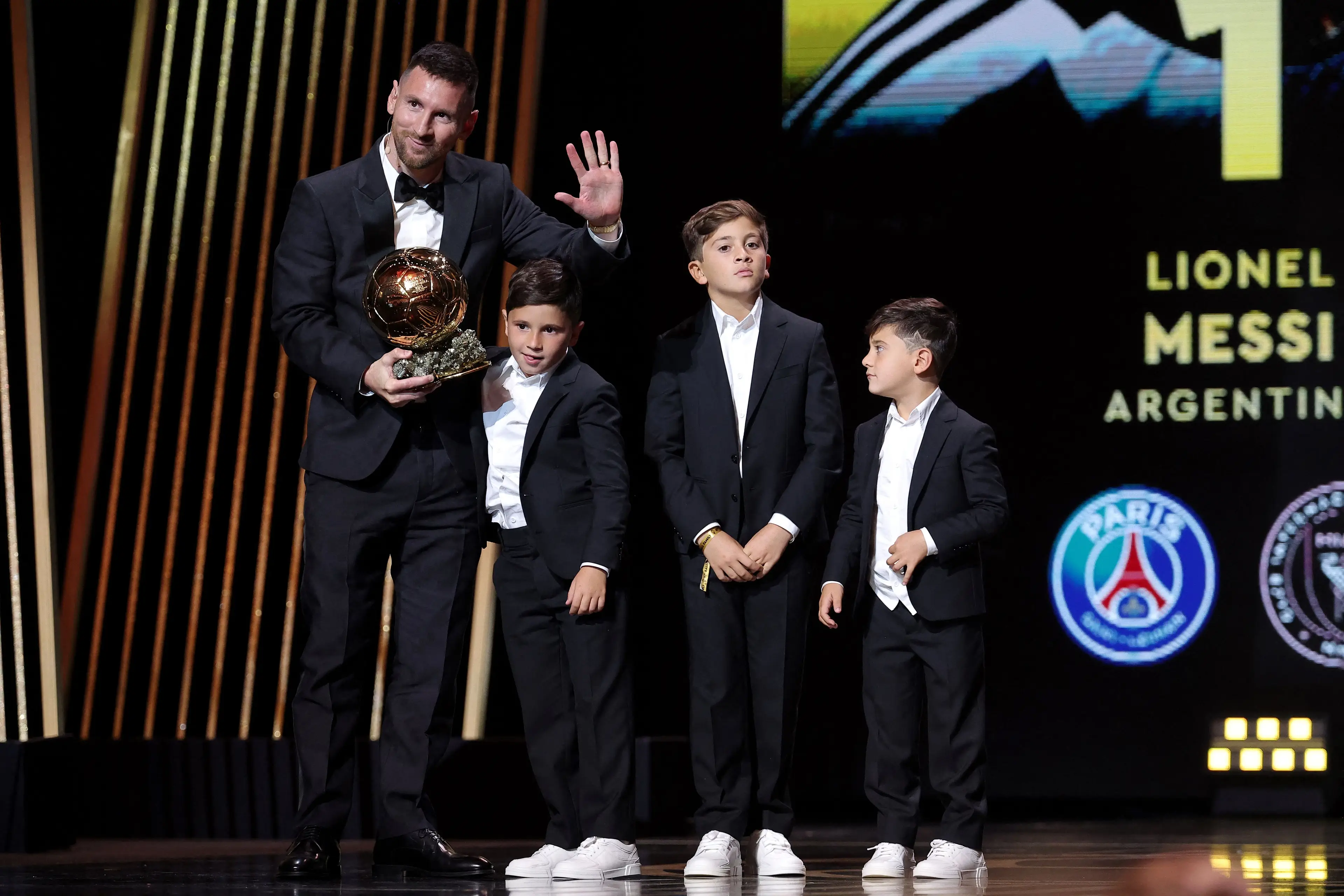 Lionel Messi on stage with his sons. Image: Getty