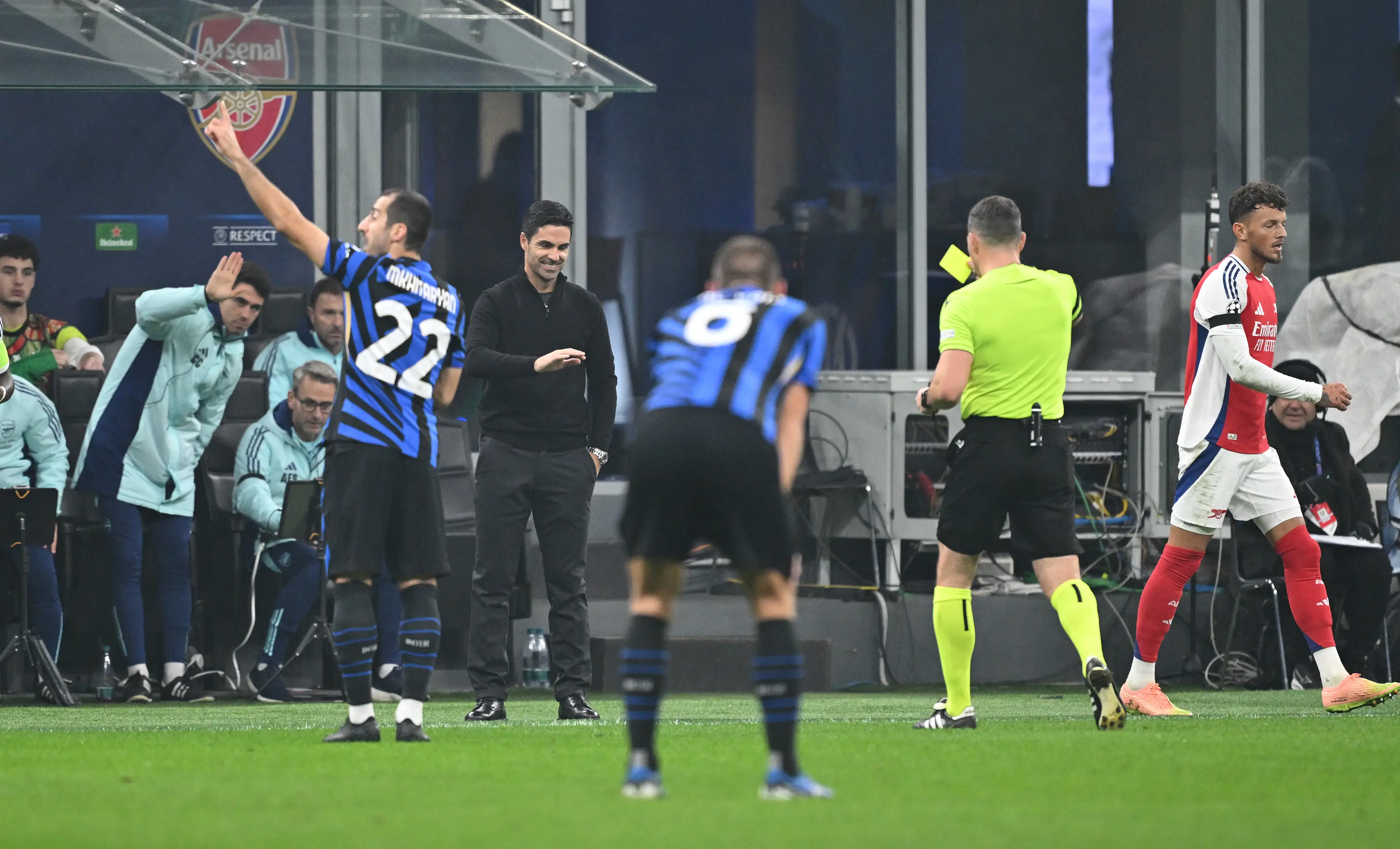 Mikel Arteta is shown a yellow card for handling the ball whilst still in play. Image: Getty