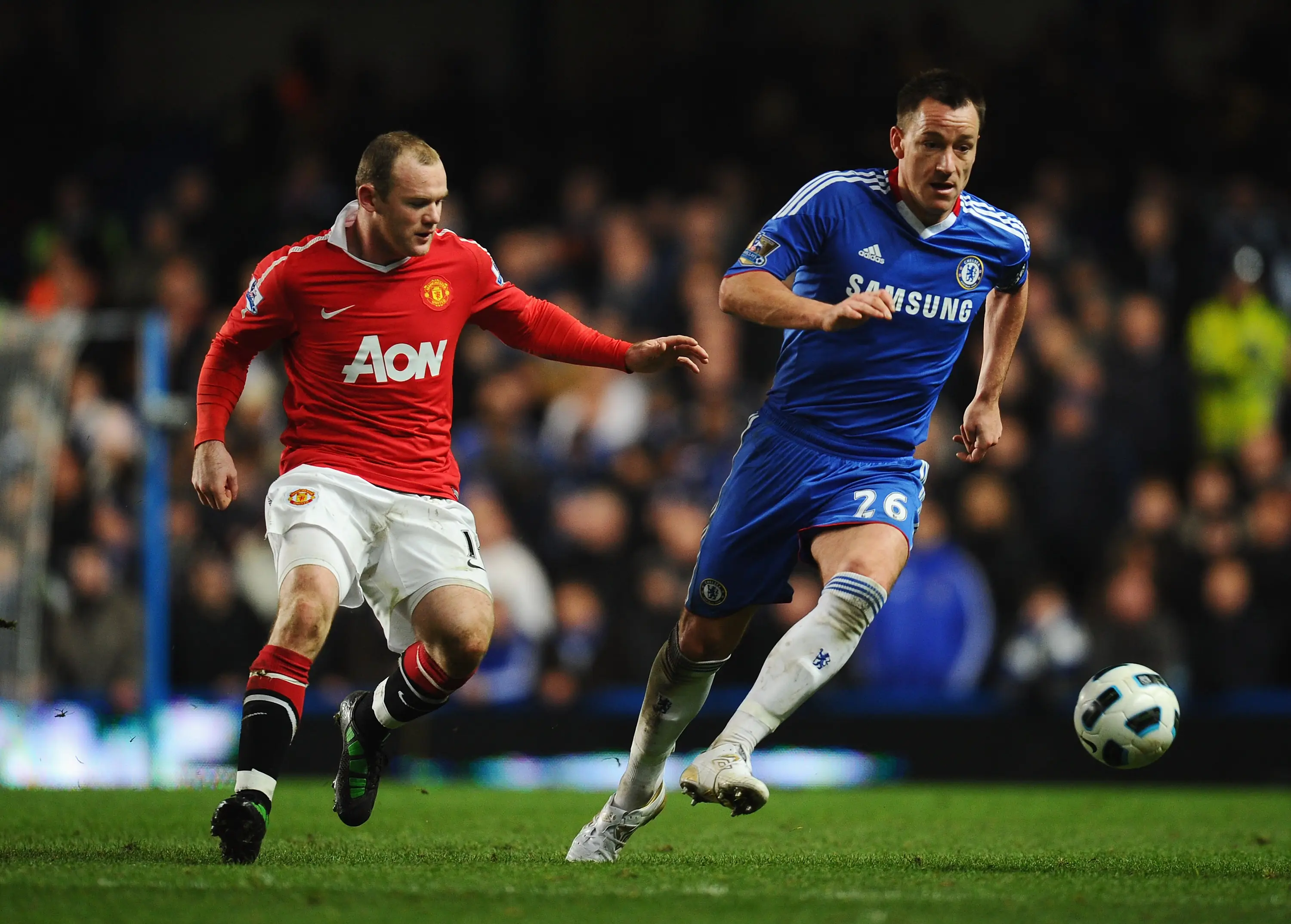 Wayne Rooney and John Terry duel for the ball. Image: Getty