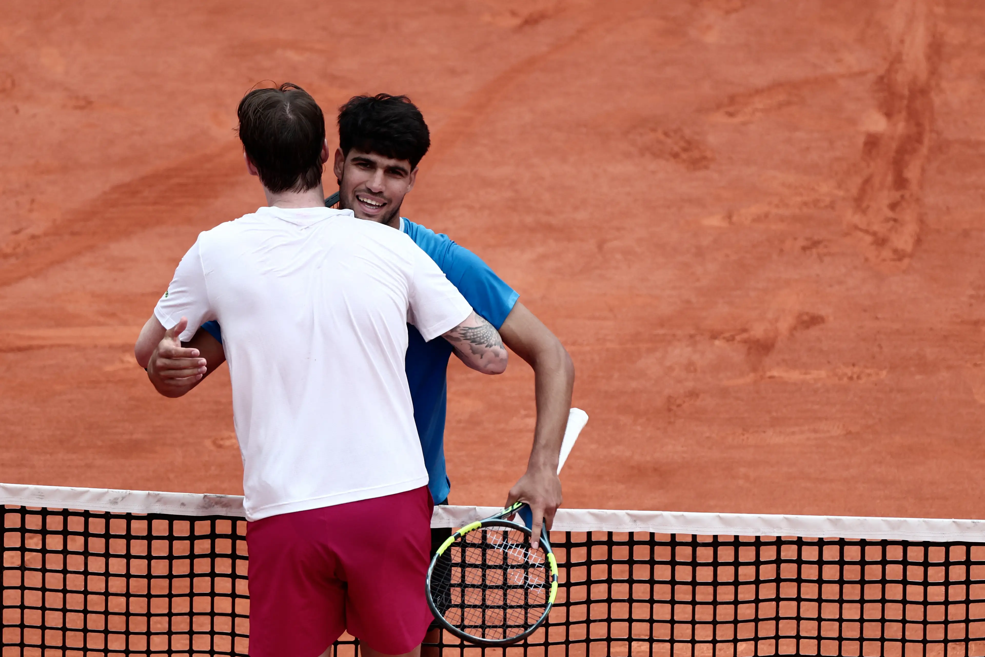 Carlos Alcaraz embraces with Alexander Bublik after their clash on Friday. Image credit: Getty