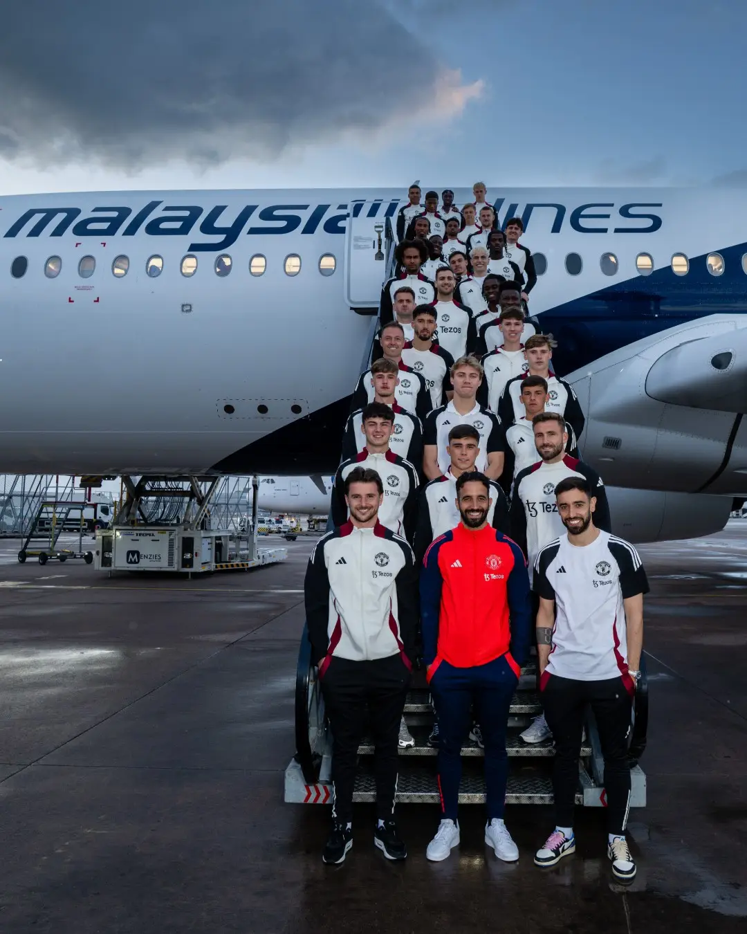 Ruben Amorim and his United squad ahead of their flight to Asia. Image credit: Manchester United/X