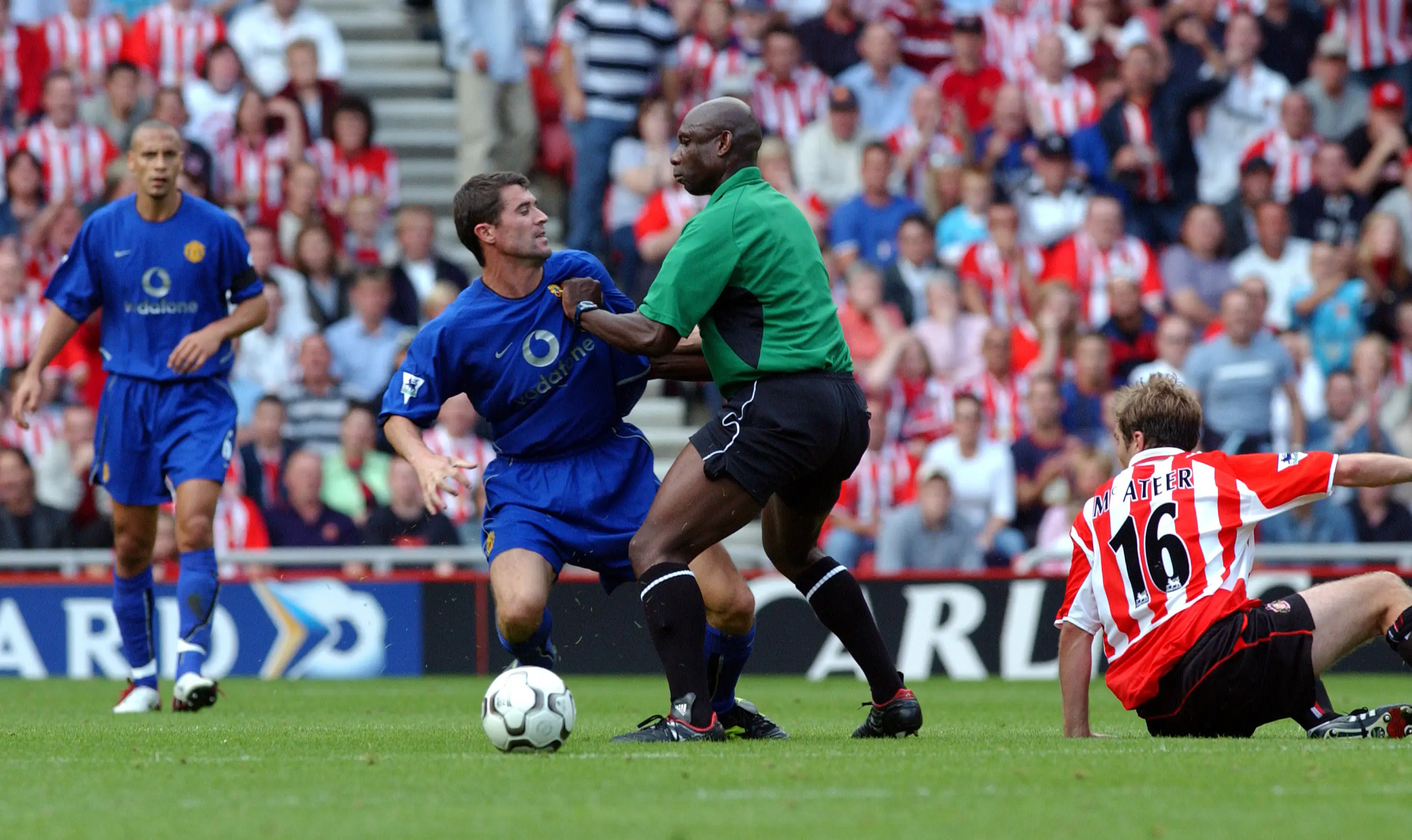 Roy Keane was held back by referee Uriah Rennie after the incident with Jason McAteer. Image credit: Getty