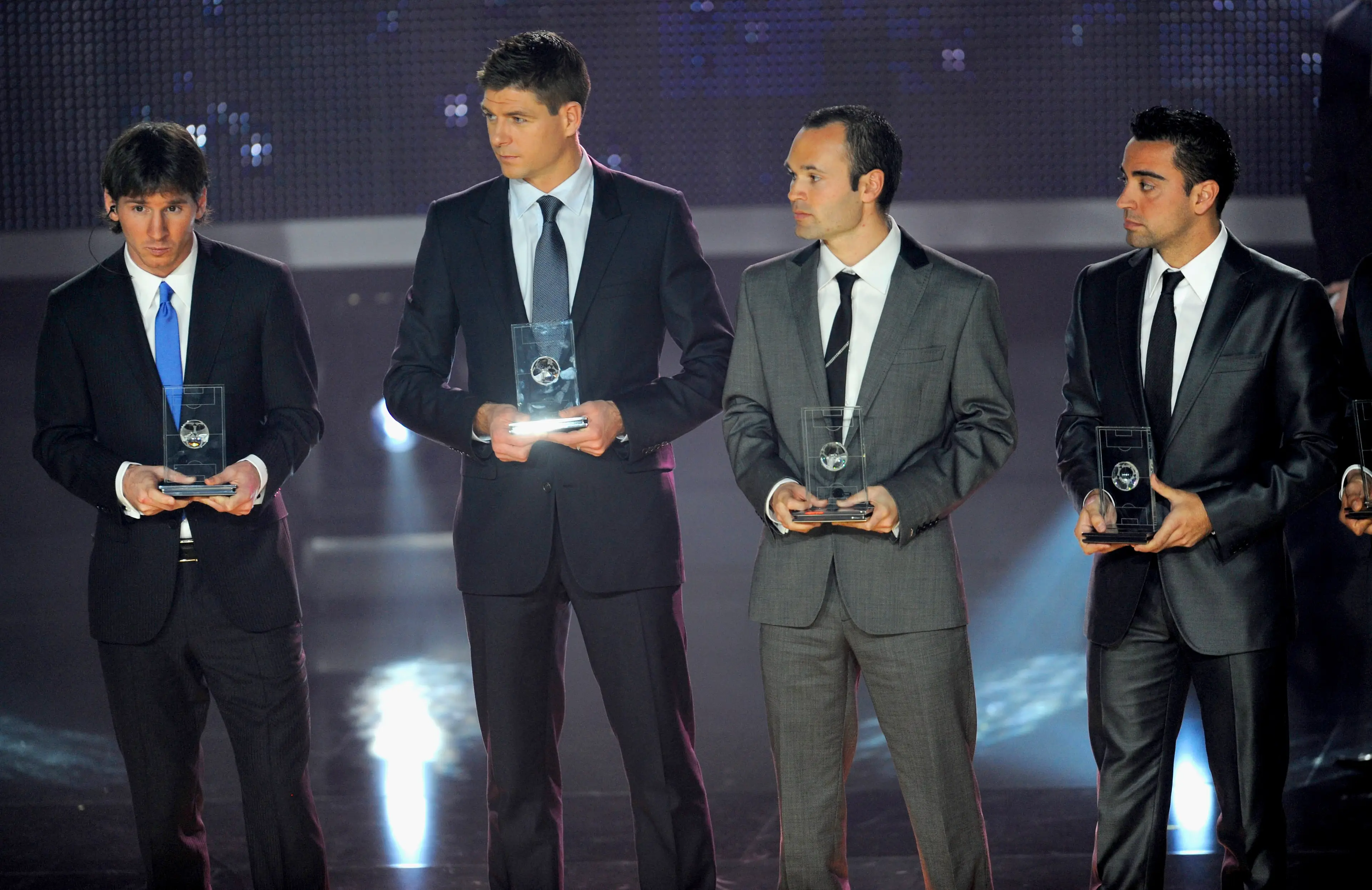 Lionel Messi, Steven Gerrard, Andres Iniesta and Xavi line up after receiving their FIFA/FIFPro World XI awards in 2009. Image credit: Getty
