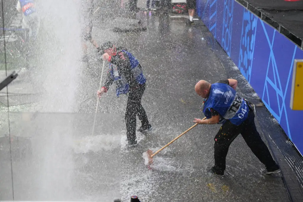 Groundstaff attempt to sweep up standing water before Turkey vs Georgia (
