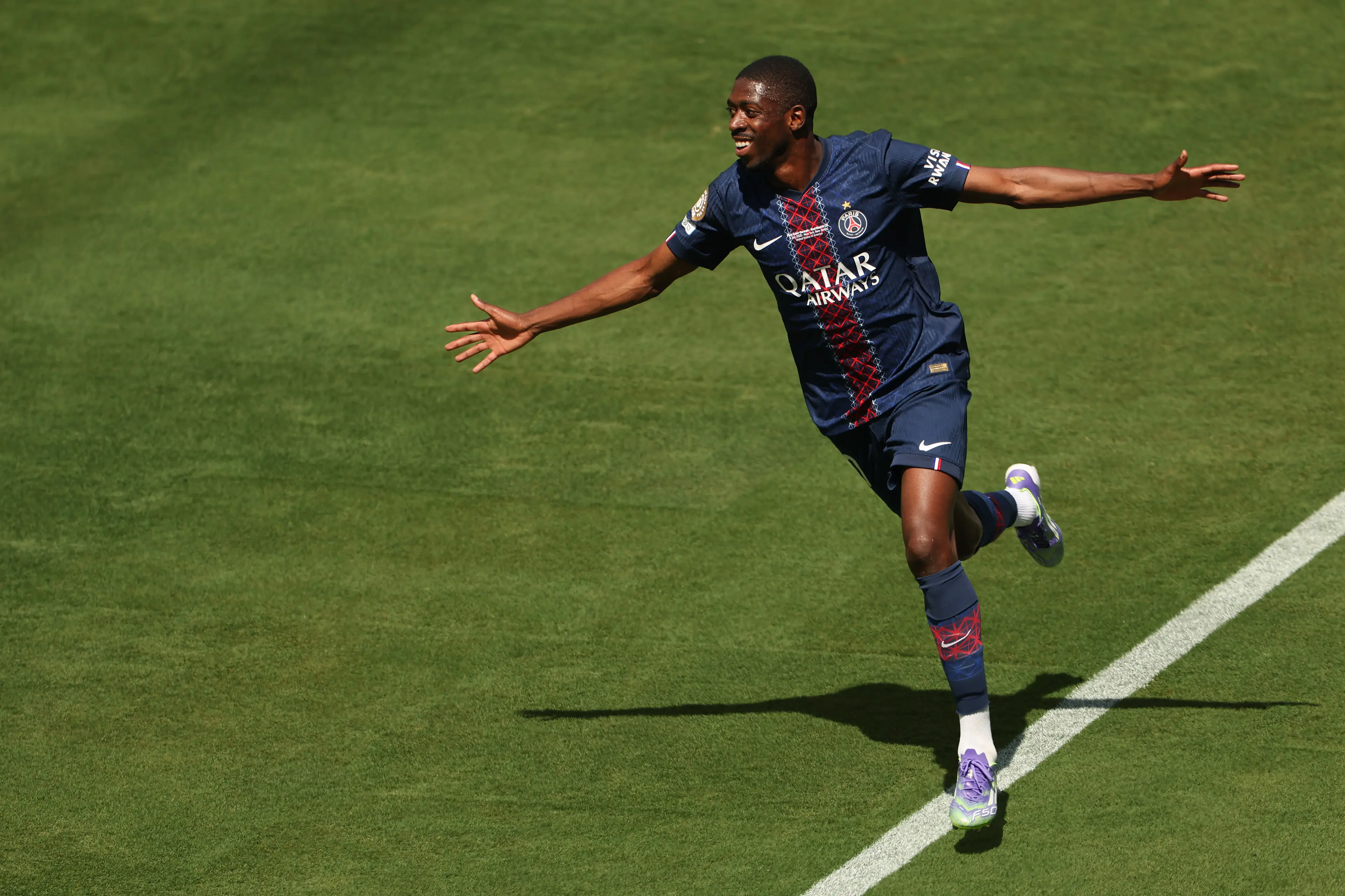 Ousmane Dembele wheels away in celebration after scoring against Real Madrid. Image: Getty