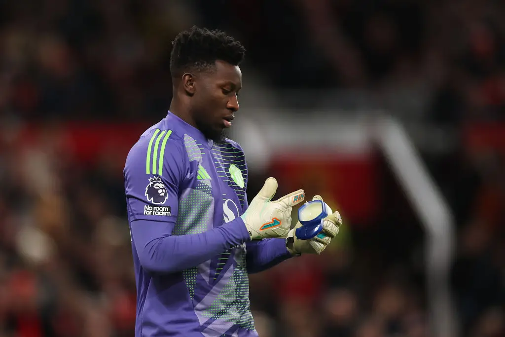 Andre Onana putting the product on his gloves (Credit:Getty)
