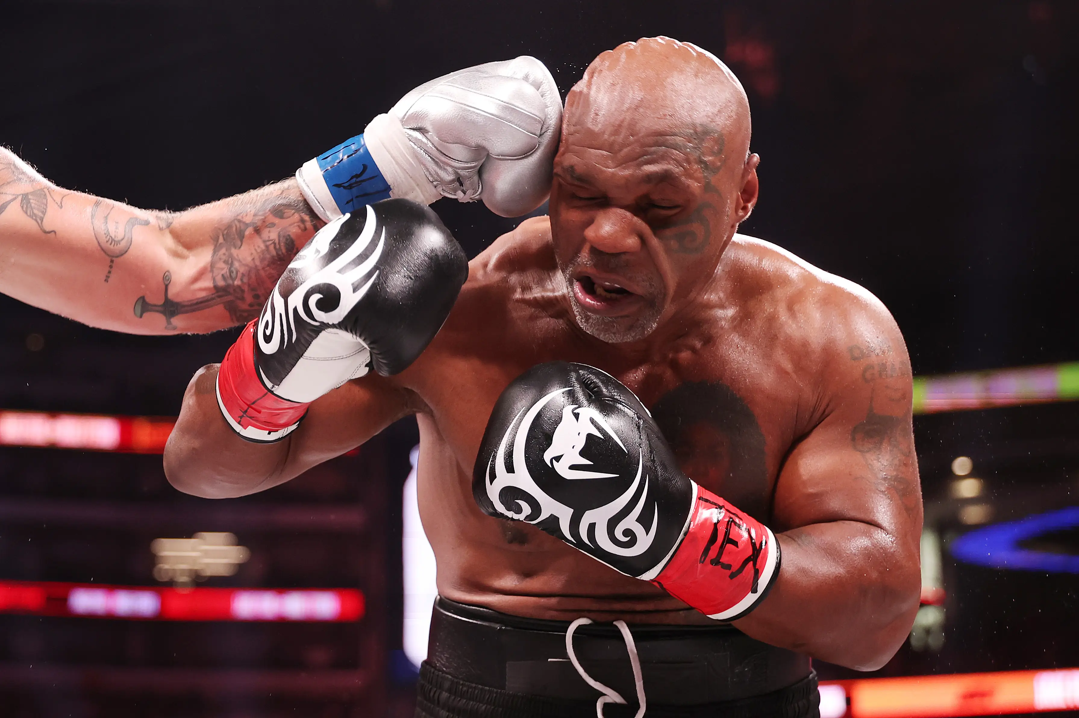 Mike Tyson eats a punch from Jake Paul. Image: Getty 