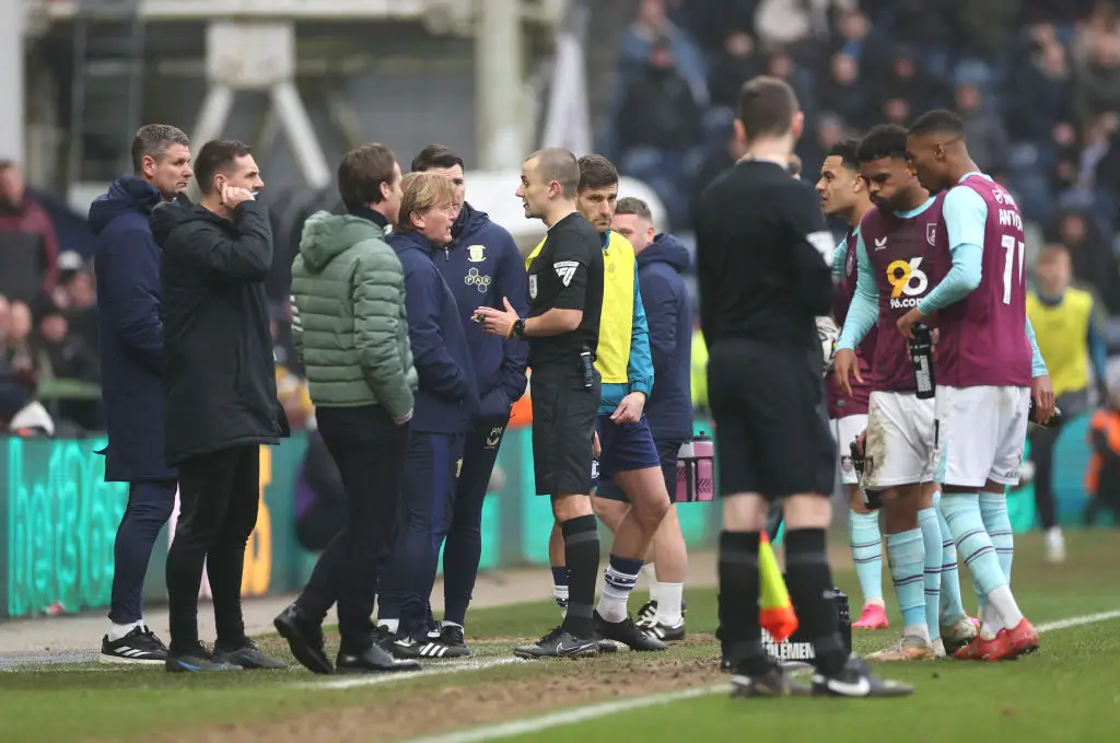 Referee Andrew Kitchen pictured in discussion with PNE assistant Stuart McCall and Burnley boss Scott Parker at Deepdale (Image: Getty)