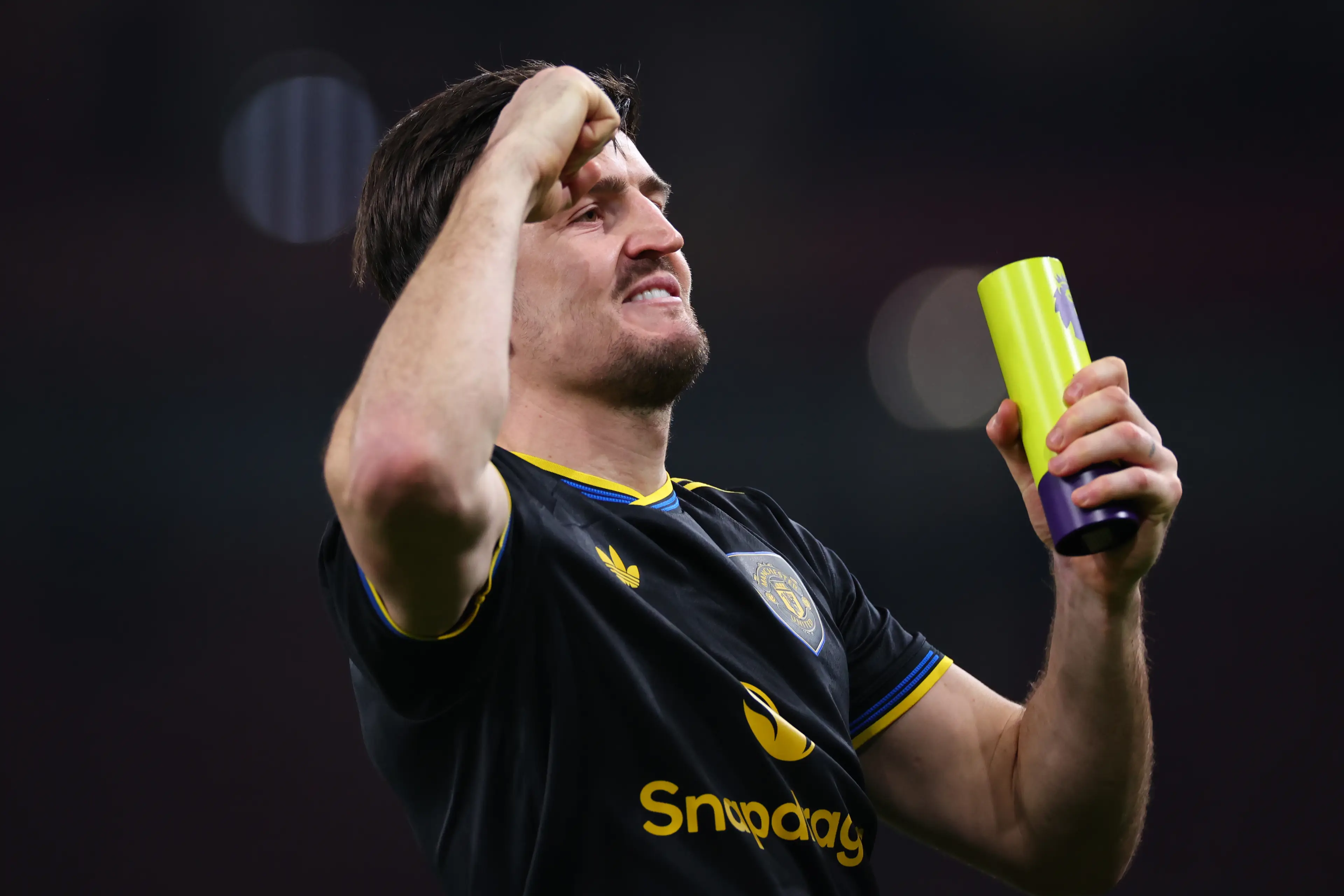 Harry Maguire celebrates Manchester United's victory over Arsenal with the Man of the Match award in his hand. Image: Getty