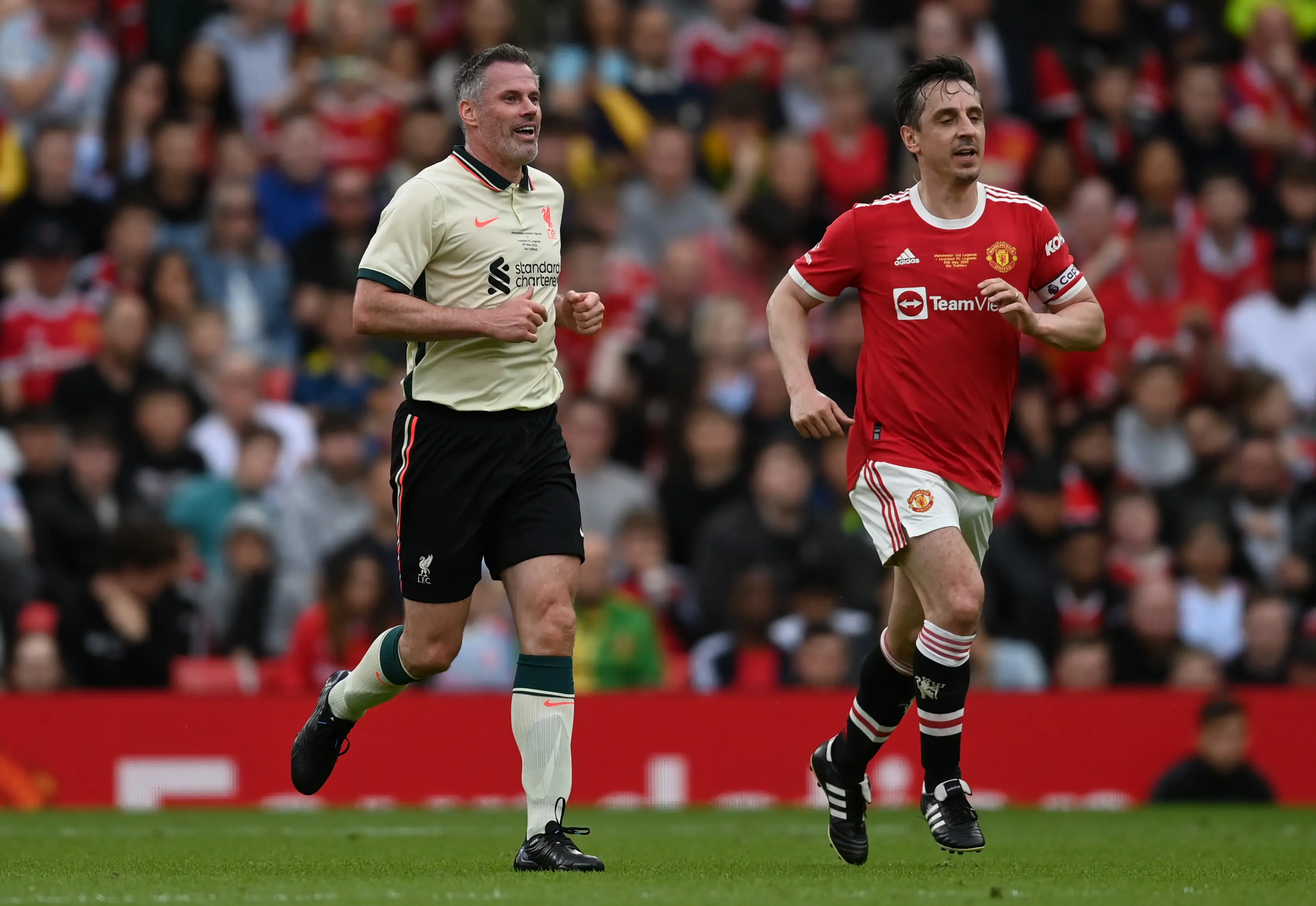Jamie Carragher and Gary Neville during a charity football match. Image: Getty 