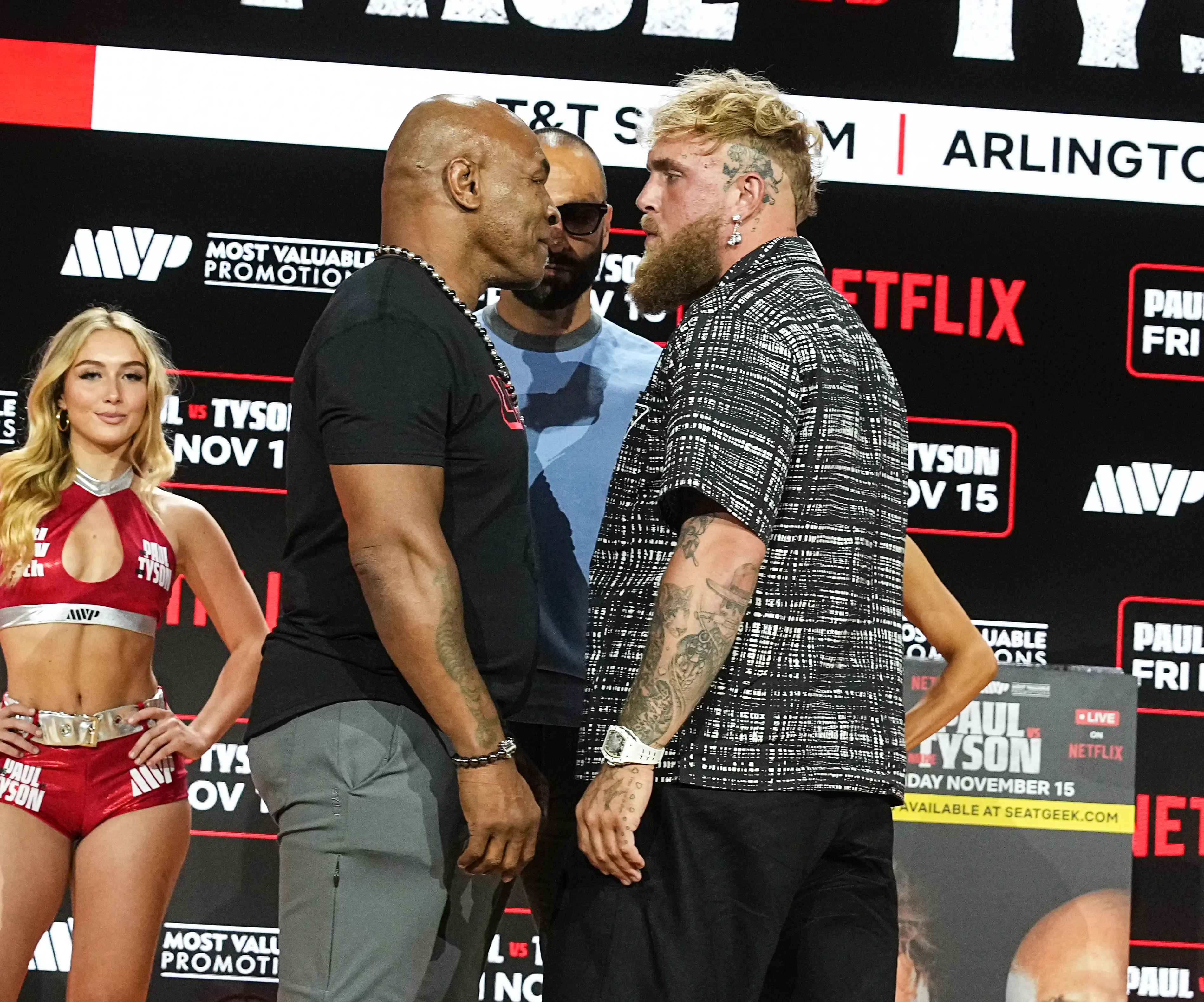 Mike Tyson and Jake Paul face off at a pre-fight presser. Image: Getty