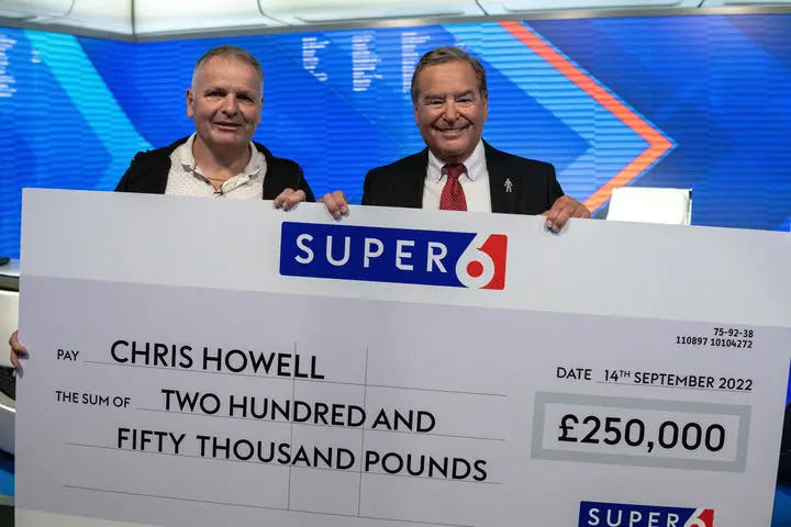 Jeff Stelling presented the cheque to Chris