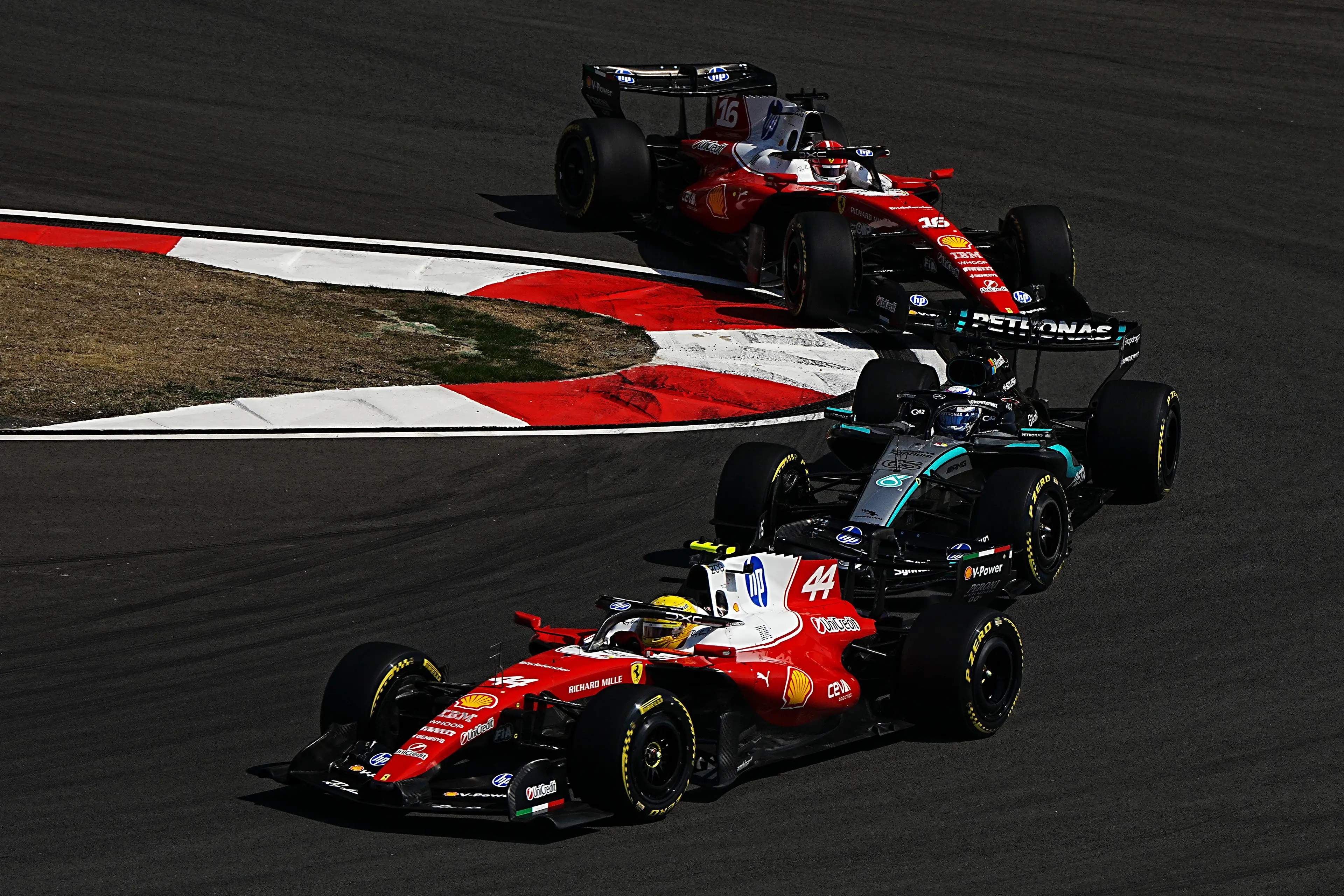 Lewis Hamilton and Charles Leclerc's Ferrari's battling George Russell in Canada (credit: getty)