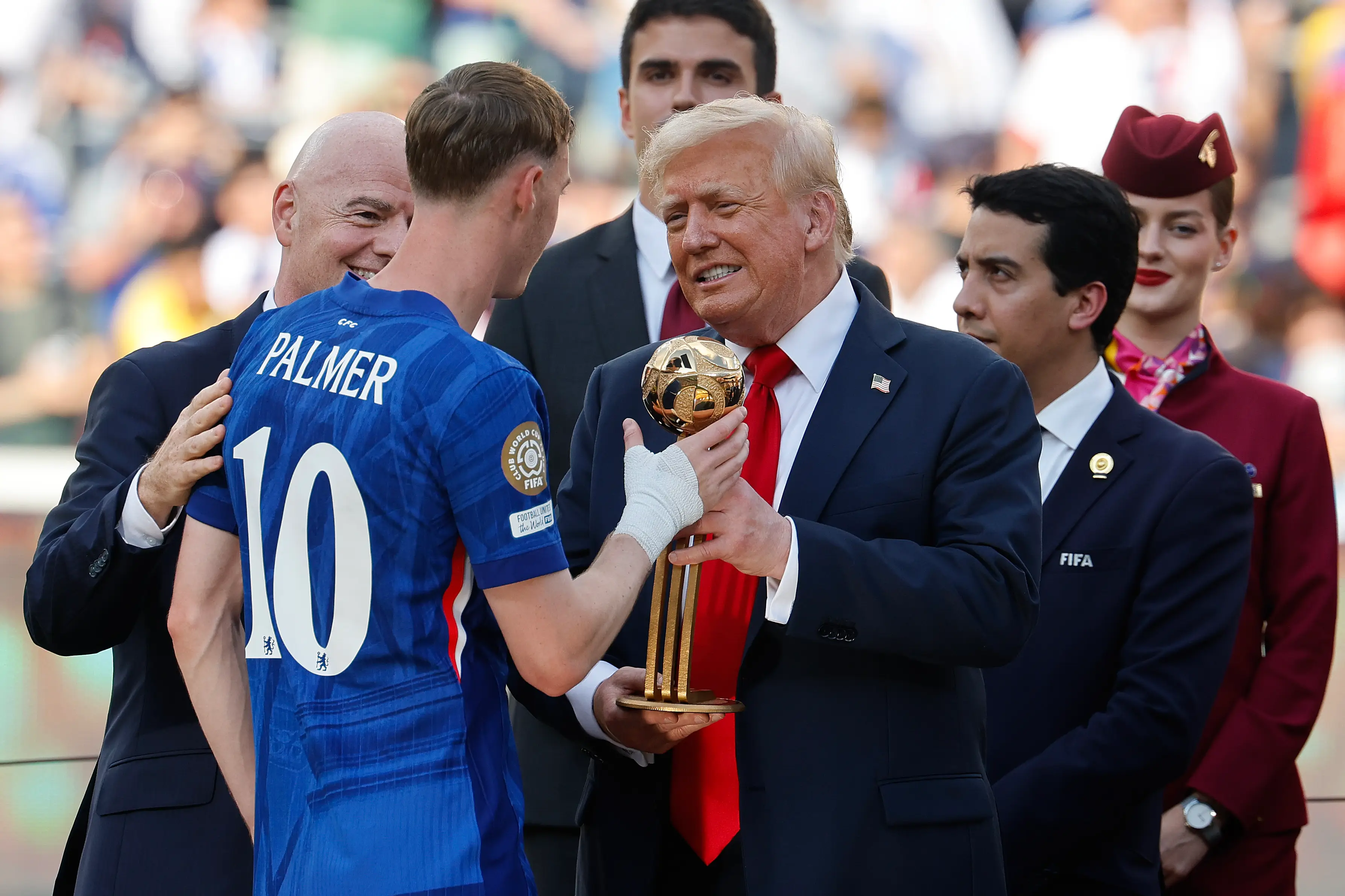Donald Trump presents a trophy to Cole Palmer at the FIFA Club World Cup. (Image: Getty)