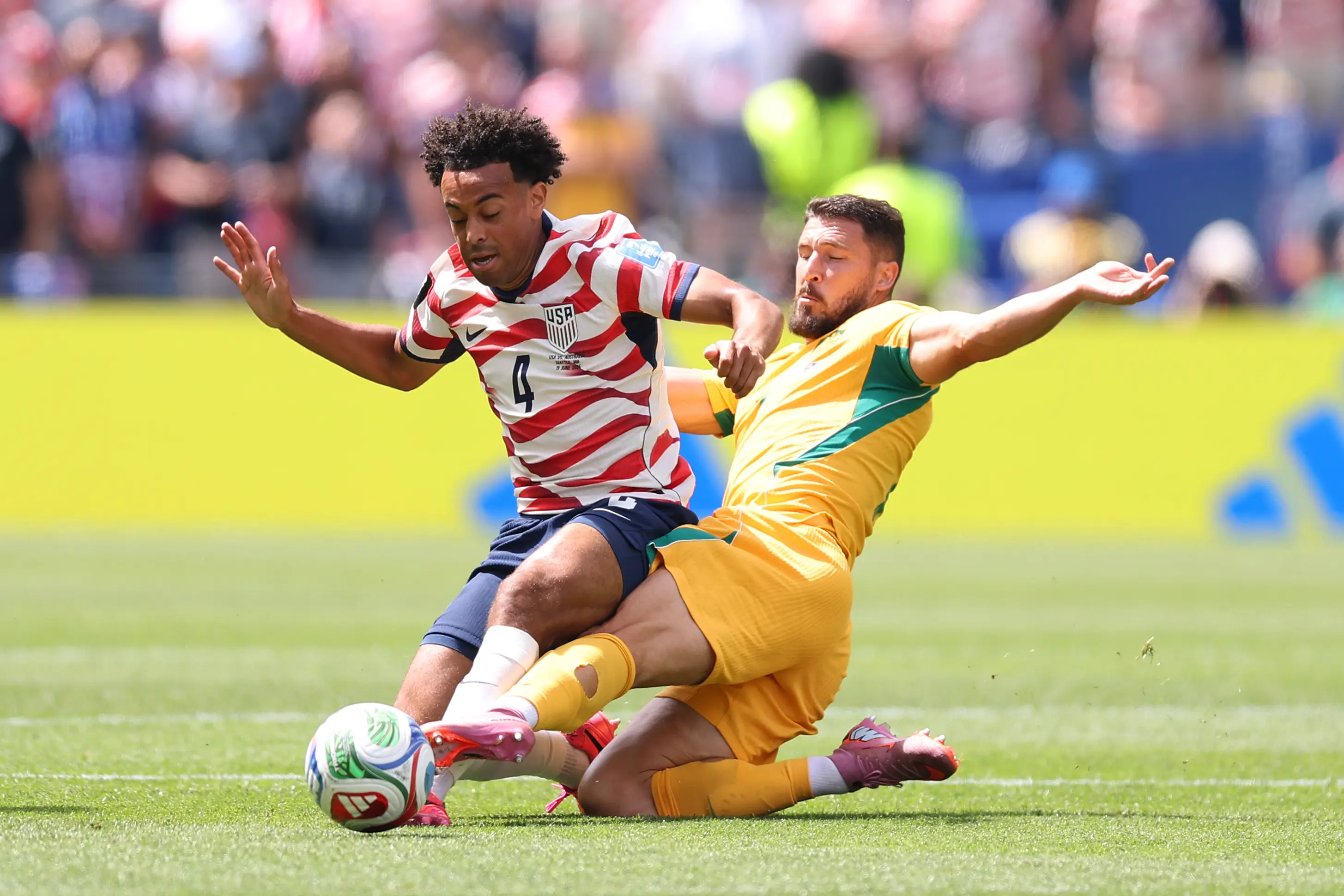 Tyler Adams #4 of the United States is tackled by Mathew Leckie #7 of Australia during the FIFA World Cup 2026 Group D