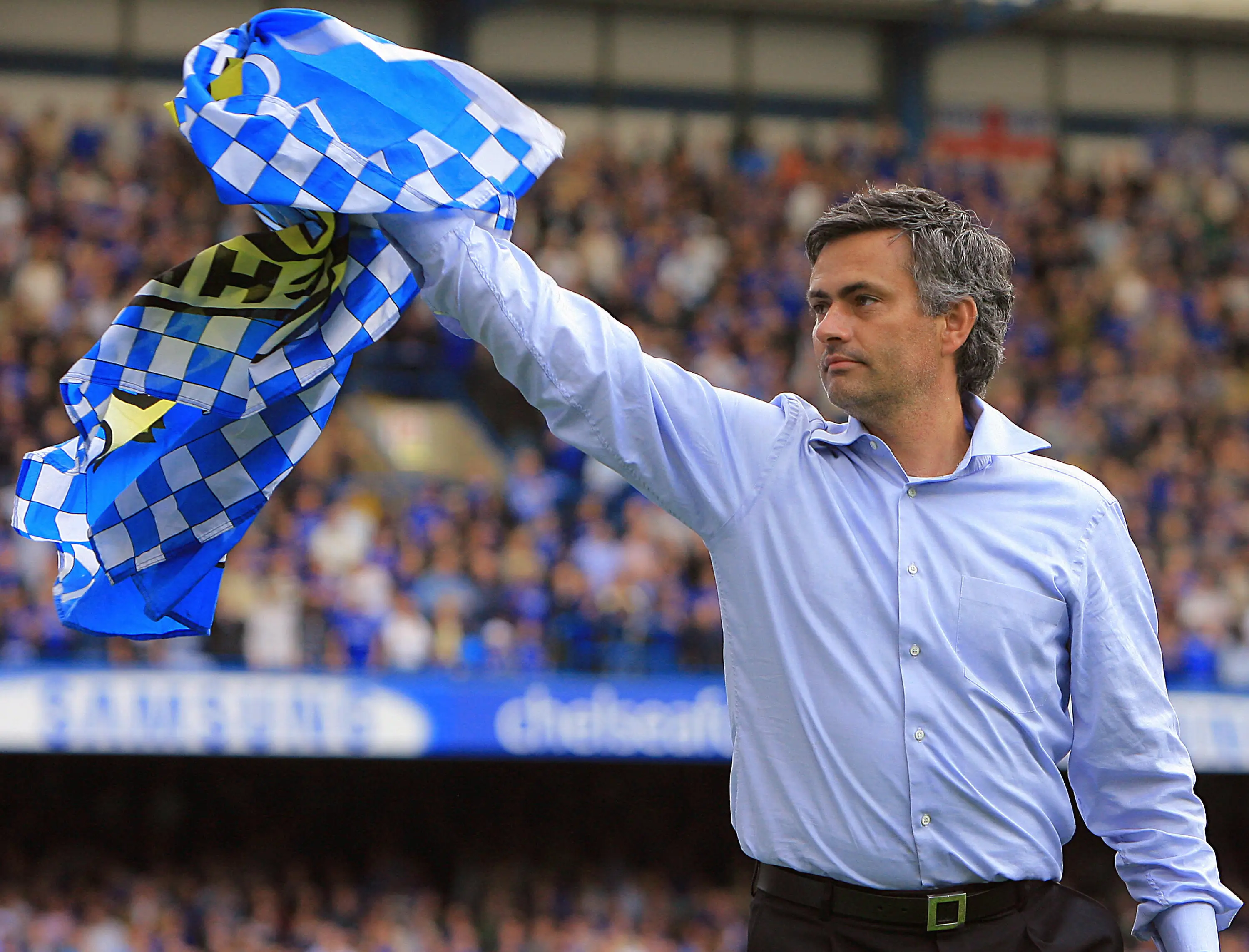 Jose Mourinho waves the Chelsea flag following win that confirmed club as champions / Photo credit ODD ANDERSEN/AFP via Getty Images