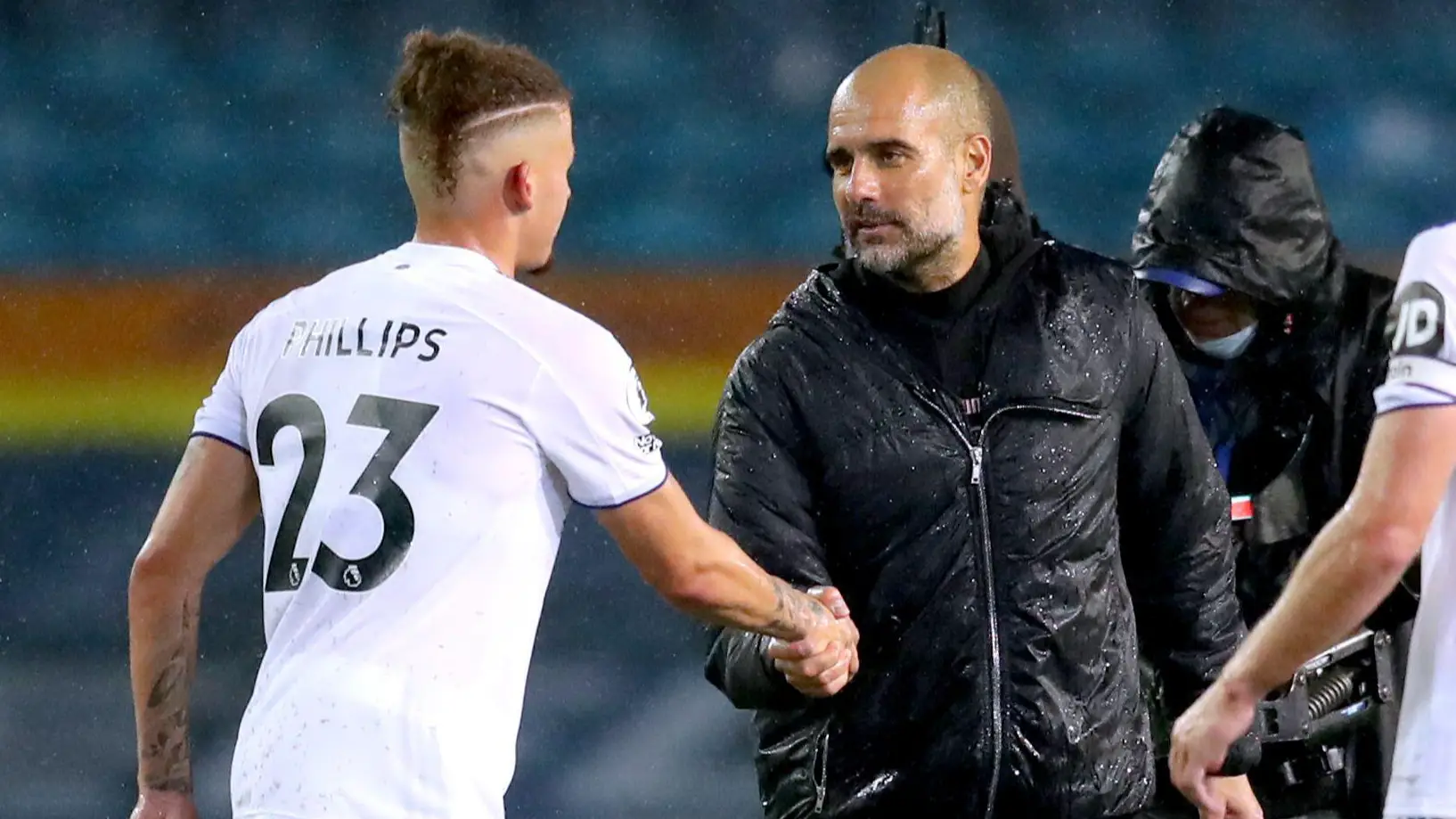 Kalvin Phillips shakes hands with Manchester City manager Pep Guardiola.