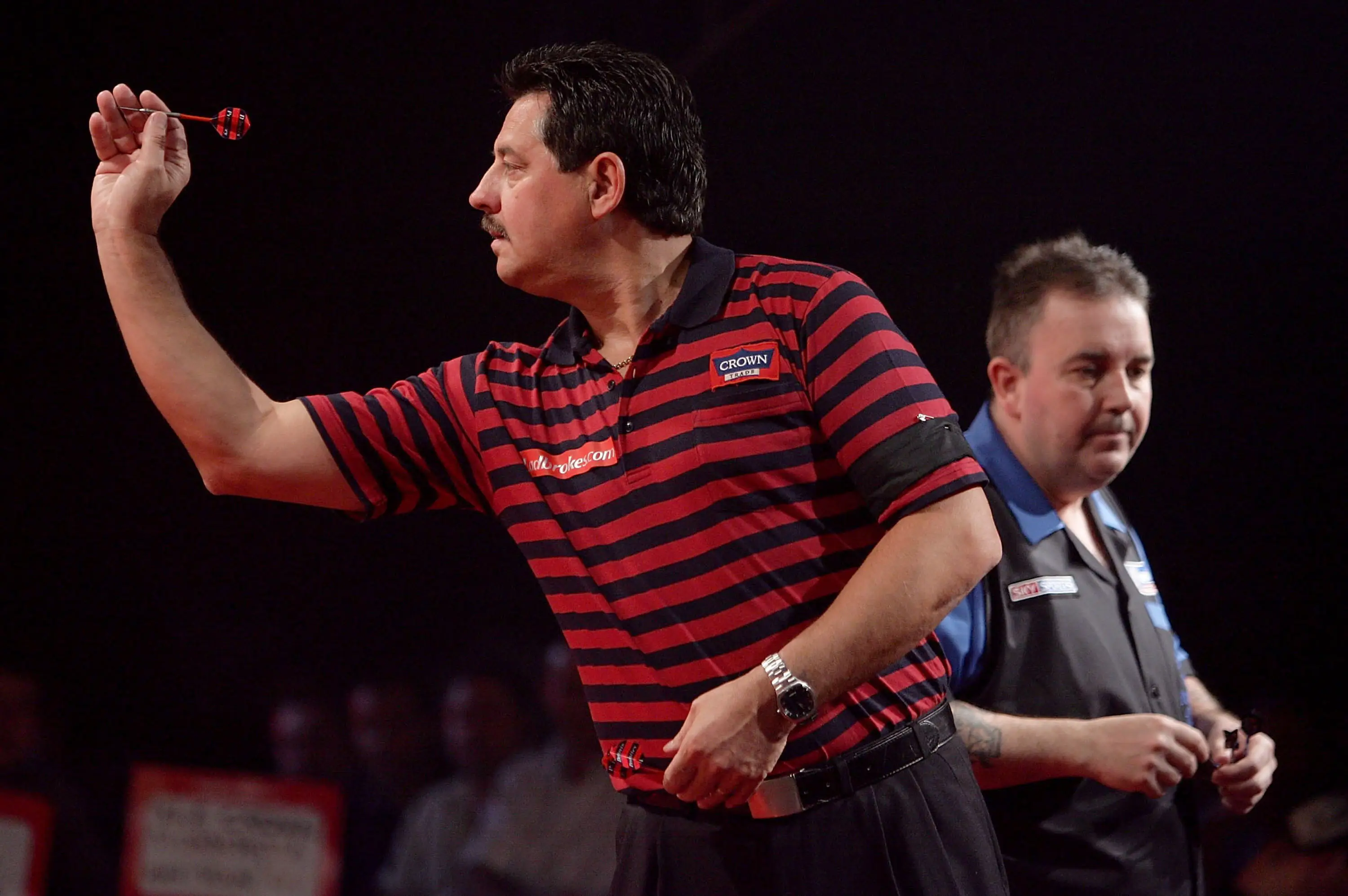 Phil Taylor and Dennis Priestley in action. (Image: Getty)