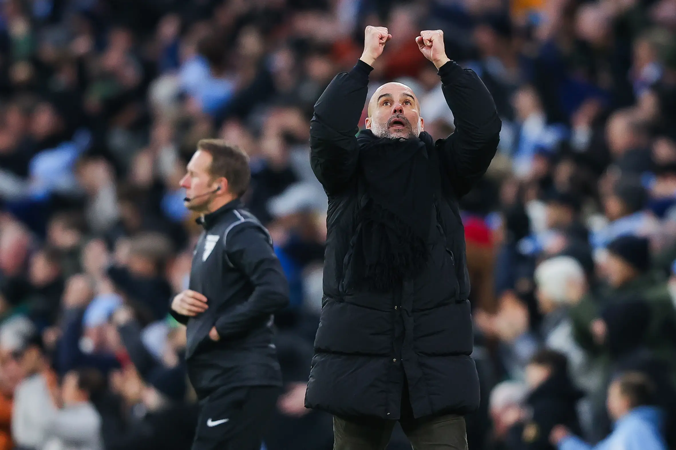 Pep Guardiola celebrates a Manchester City goal on the touchline. image: Getty