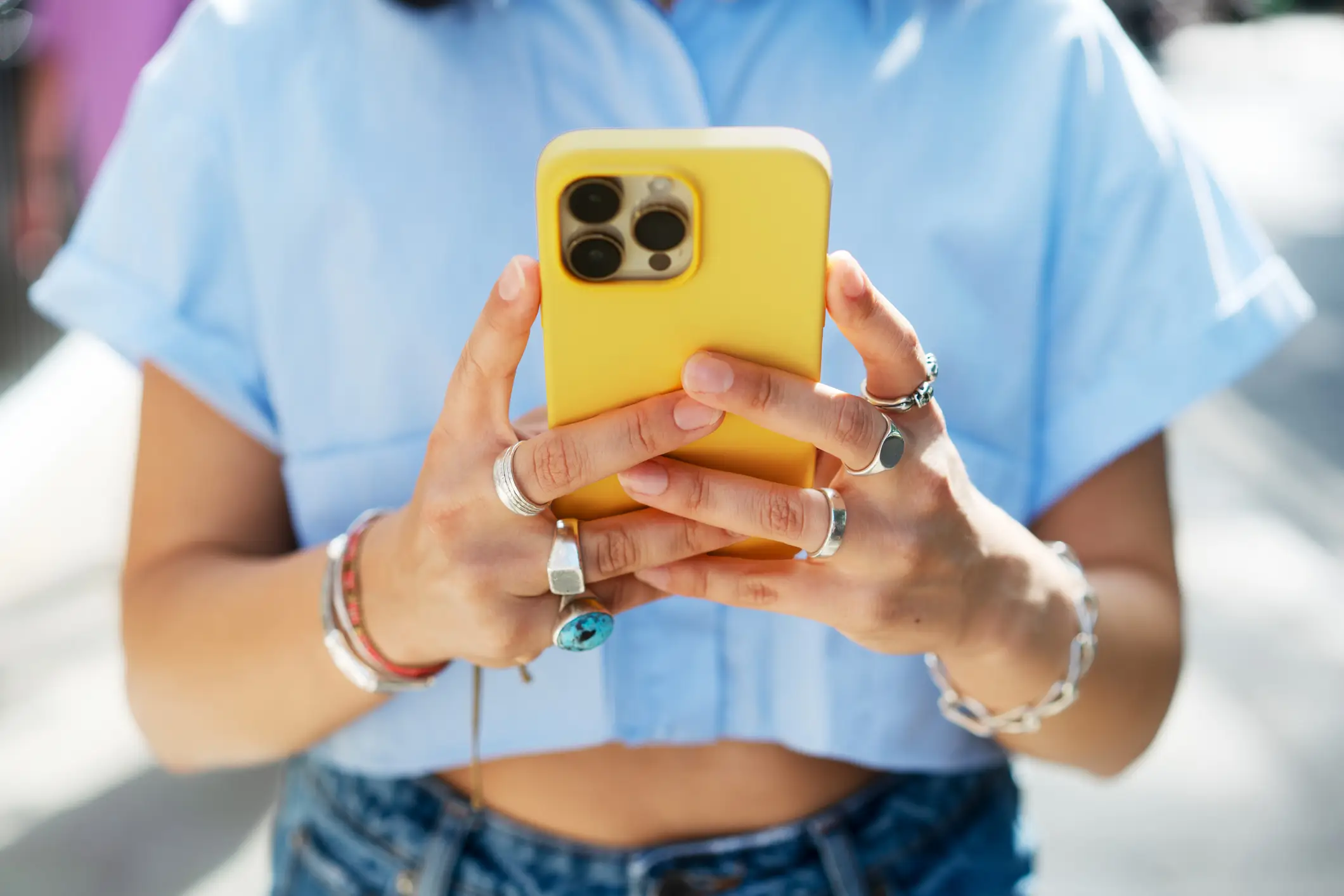 A woman holding up a smartphone (Getty Images)