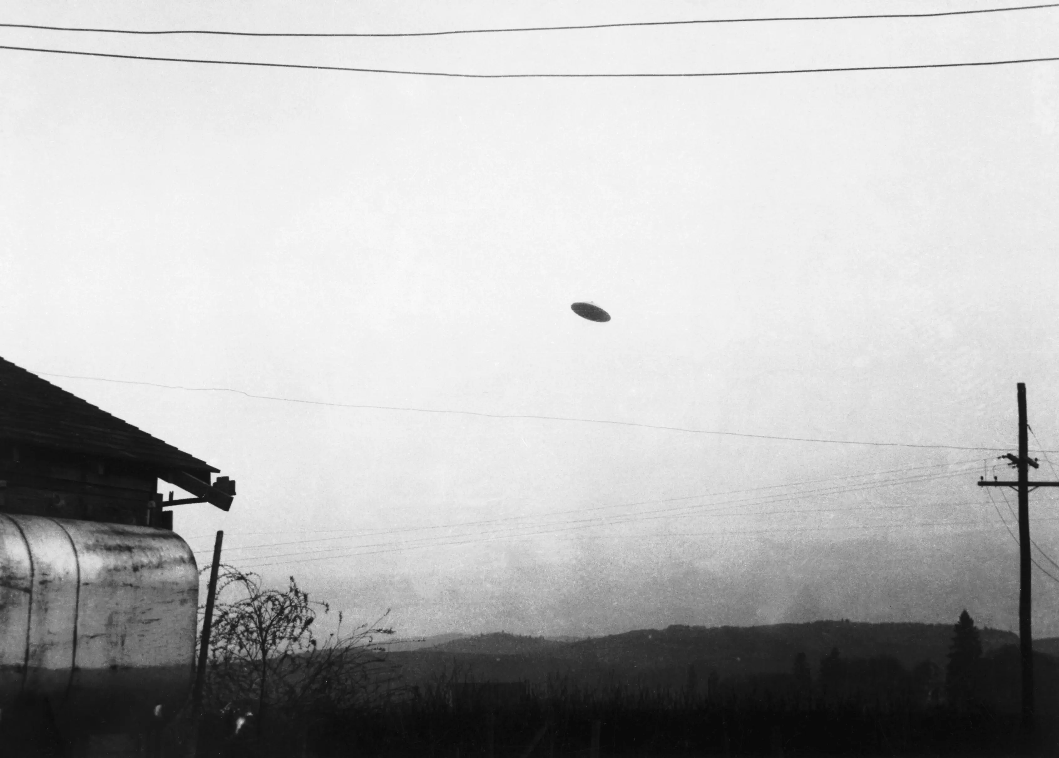 A picture of a reported flying saucer photographed by farmer Paul Trent shown flying over his farm taken in 1950.