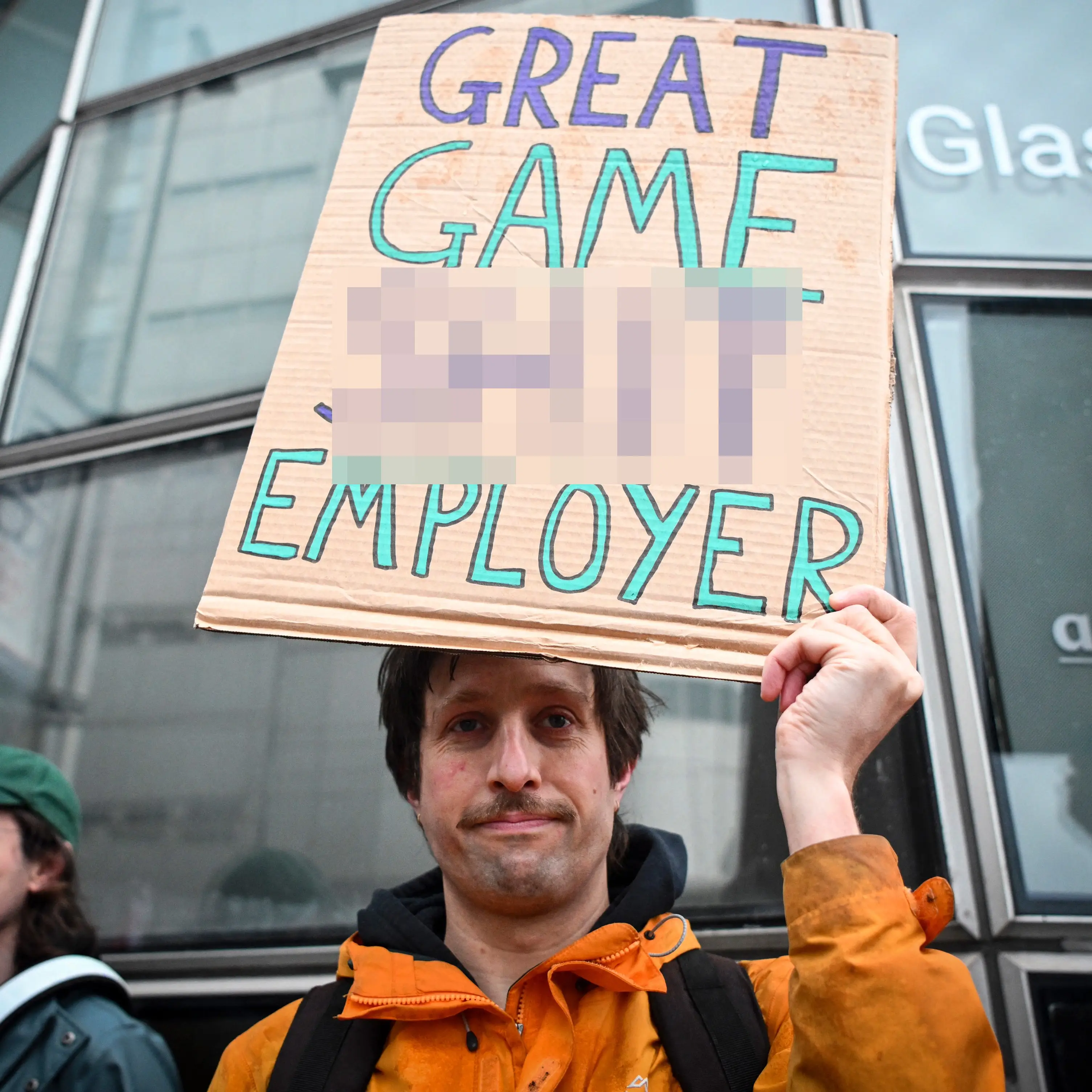 Protester holds placard as they take part in a Rockstar rally (Credit: ANDY BUCHANAN / Contributor)