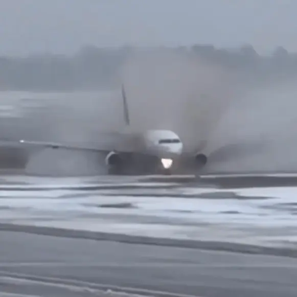 Terrifying moment passenger plane skids through mud after landing on icy runway
