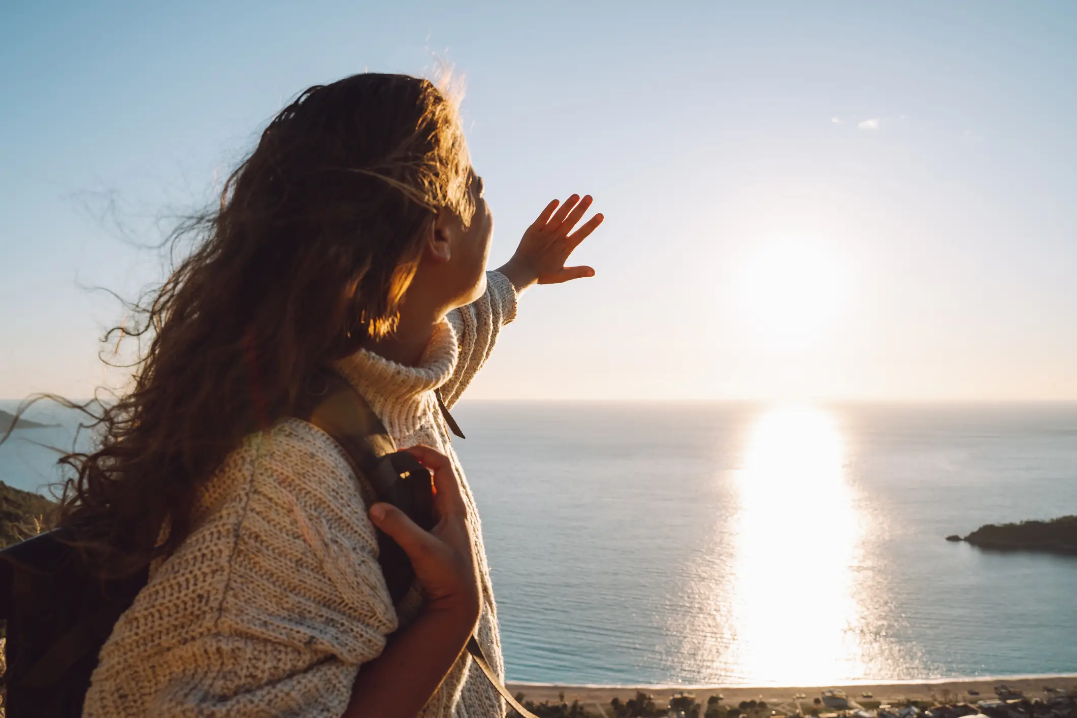 A woman protecting her eyes from the sun (Getty Images)