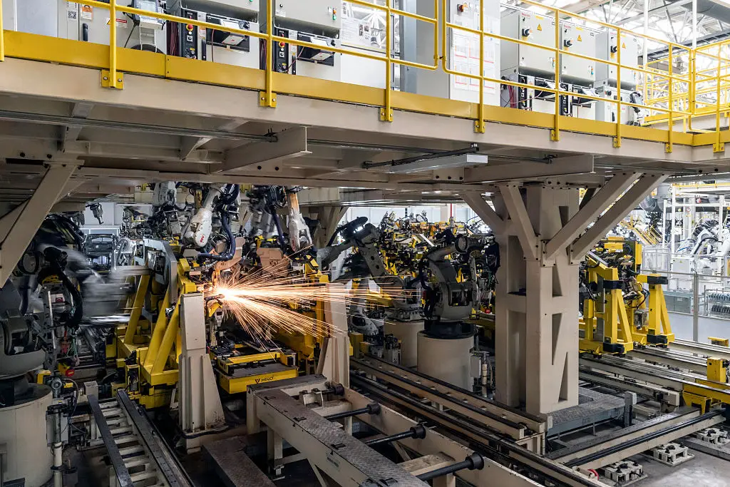 Robotic arms operating on a China body shop floor (Getty Images)
