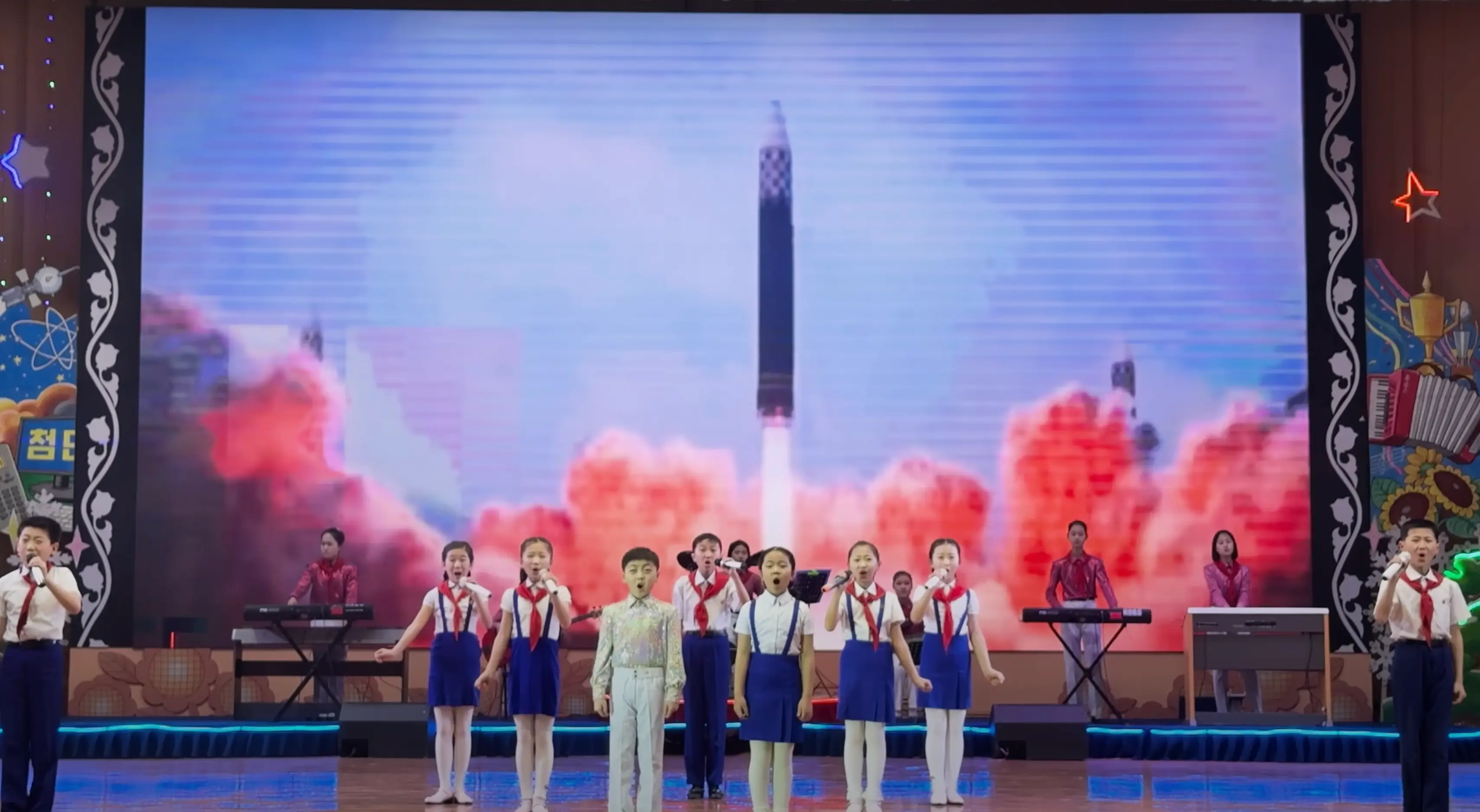 The YouTuber watched a group of children sing in front of footage of missiles (YouTube/@mikeokay)