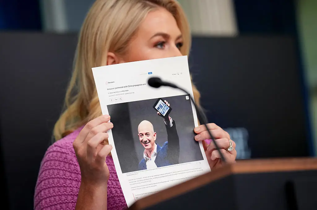 Karoline Leavitt holding news article on Jeff Bezos