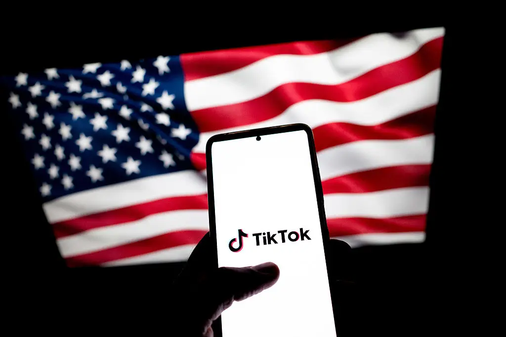 TikTok being used in front of an American flag (Getty Images)