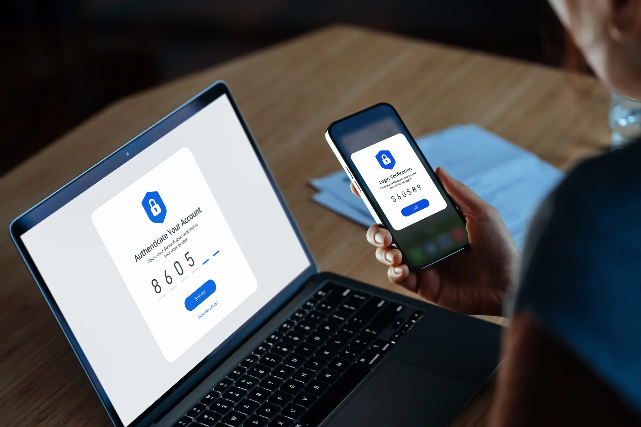 A young woman using mobile device with Two-Factor Authentication (2FA) security while logging in securely to her laptop (Getty Images)