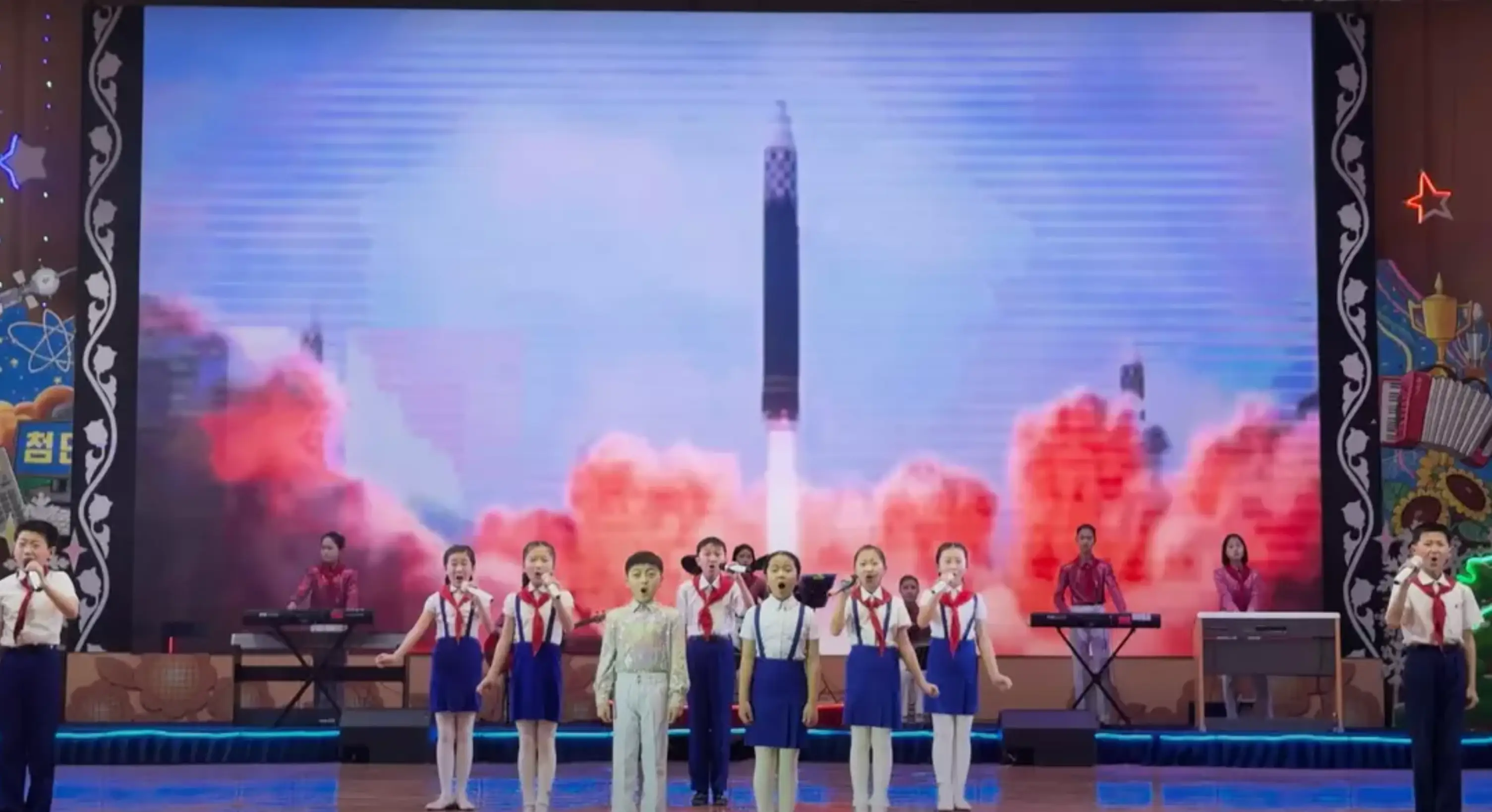 The YouTuber watched a group of children sing in front of footage of missiles (YouTube/@mikeokay)